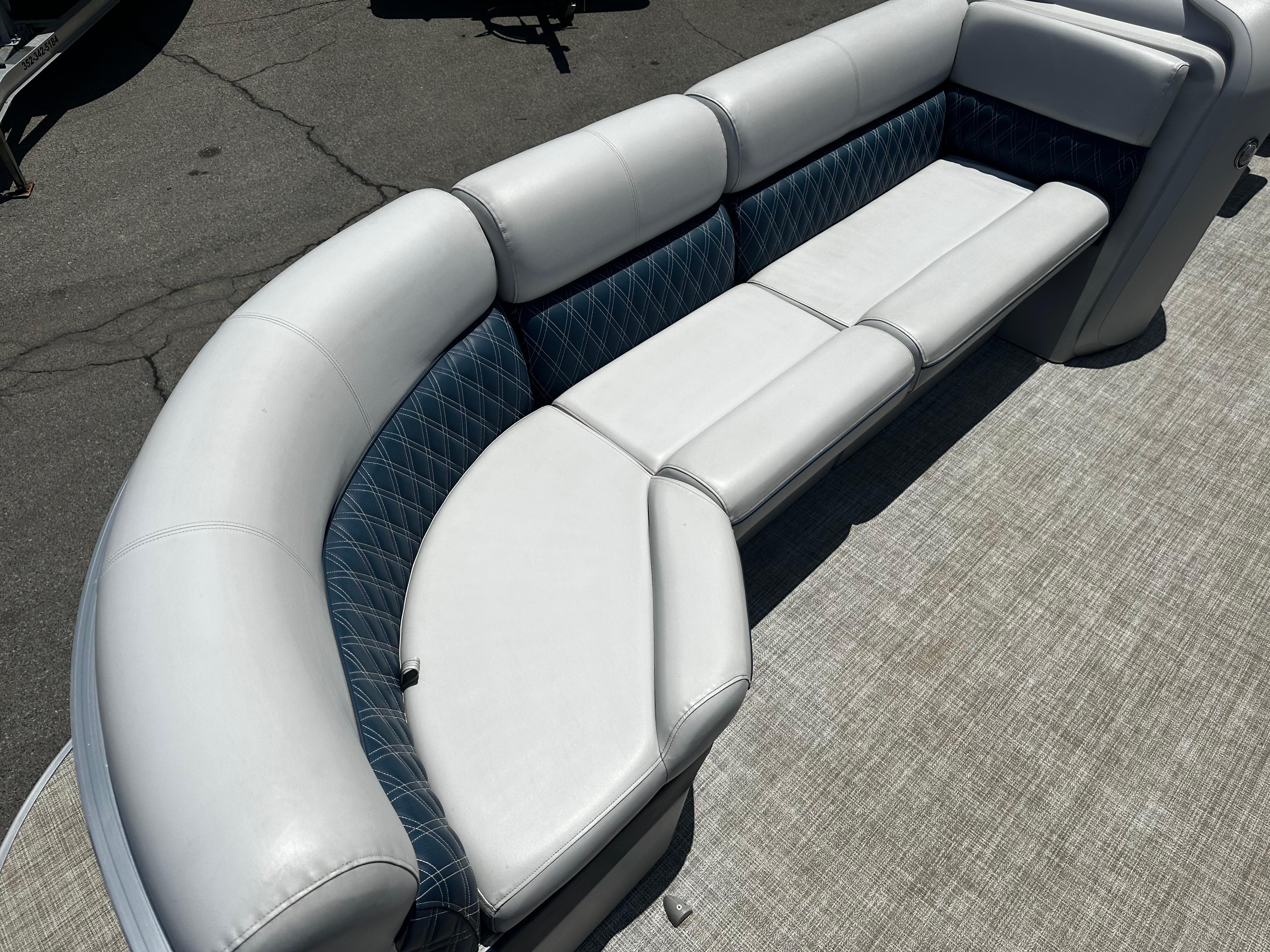 2022 Nepallo CW24-ST24QL boat with white and blue cushioned seating.