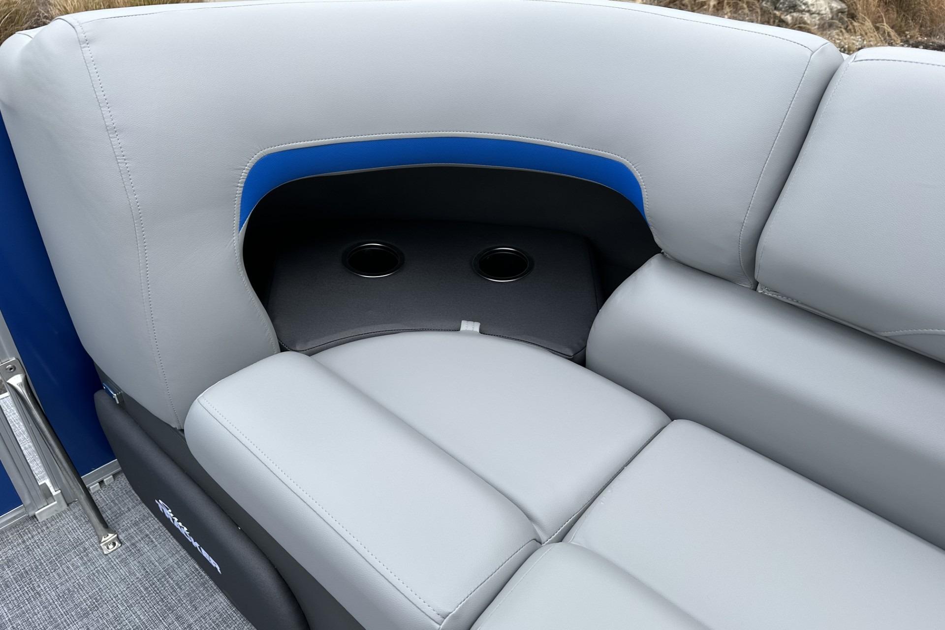 2026 Sun Tracker Party Barge 20 DLX, gray seating with cup holders, blue accent.