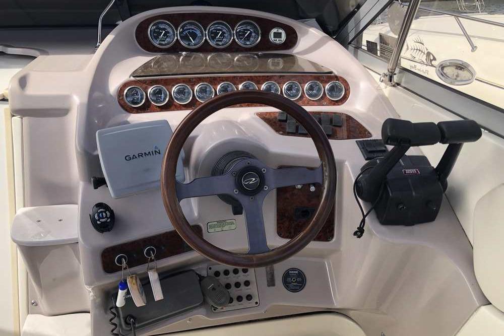 1999 Regal Commodore 2760 boat dashboard with Garmin GPS and classic wood accents.