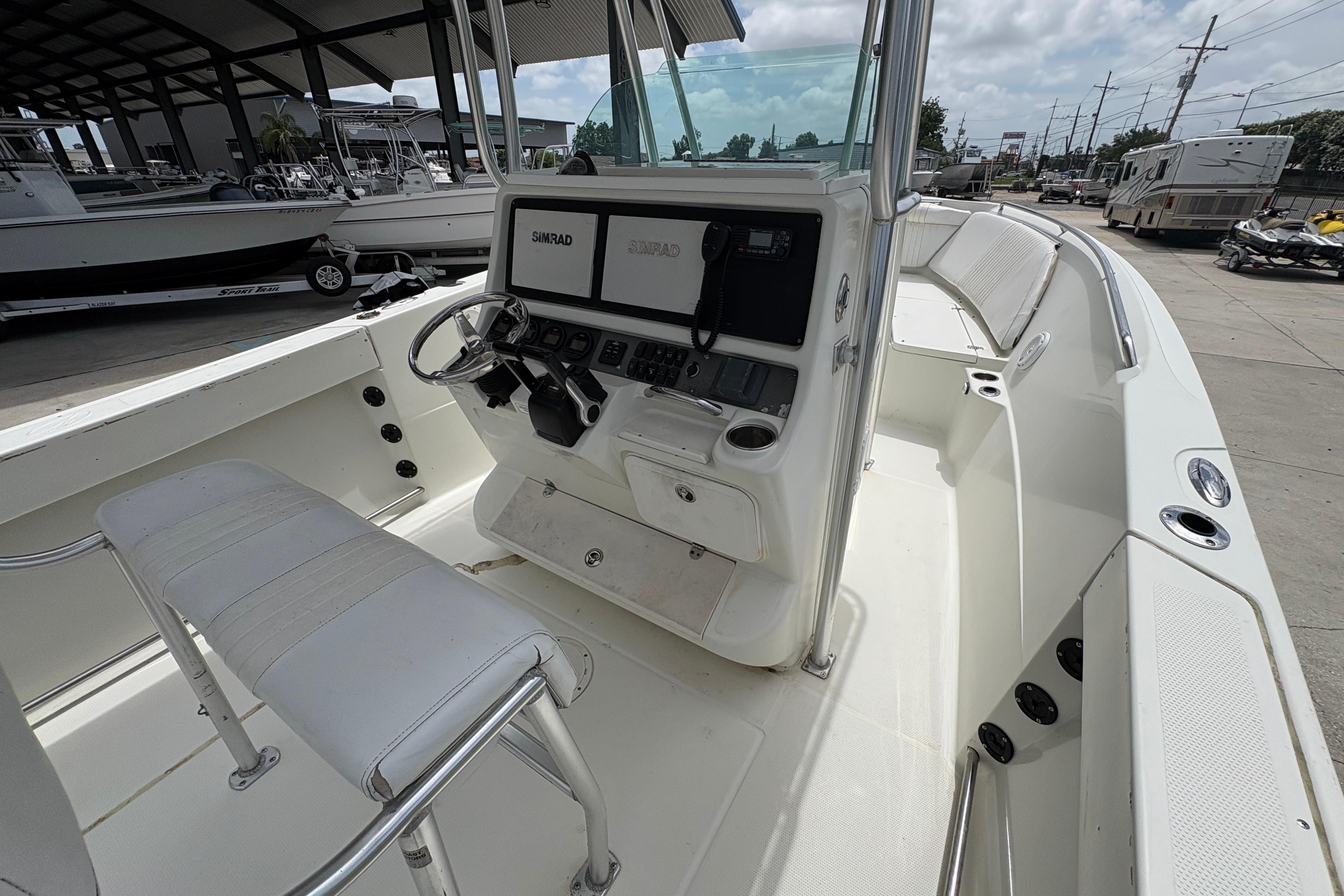 2006 Sail Faish 2360 boat interior with steering console and seating, docked outdoors.