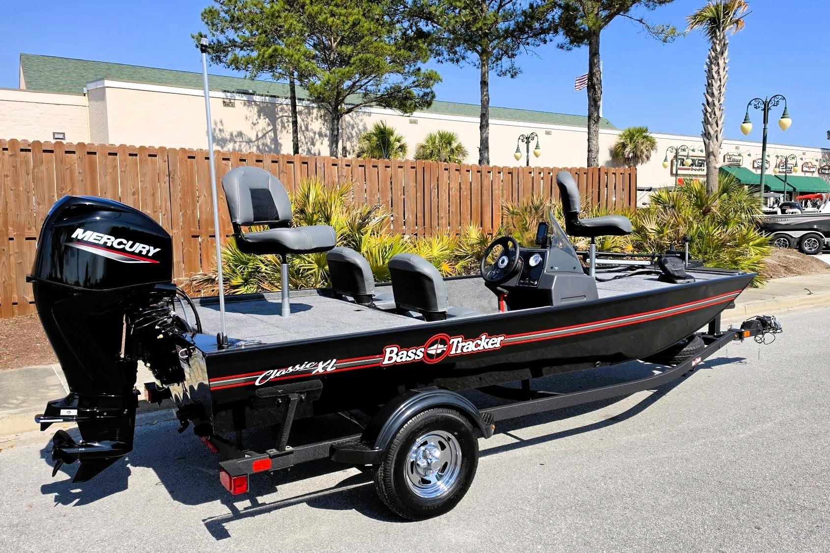 2026 Tracker Bass Tracker Classic XL fishing boat with Mercury engine, parked outdoors.