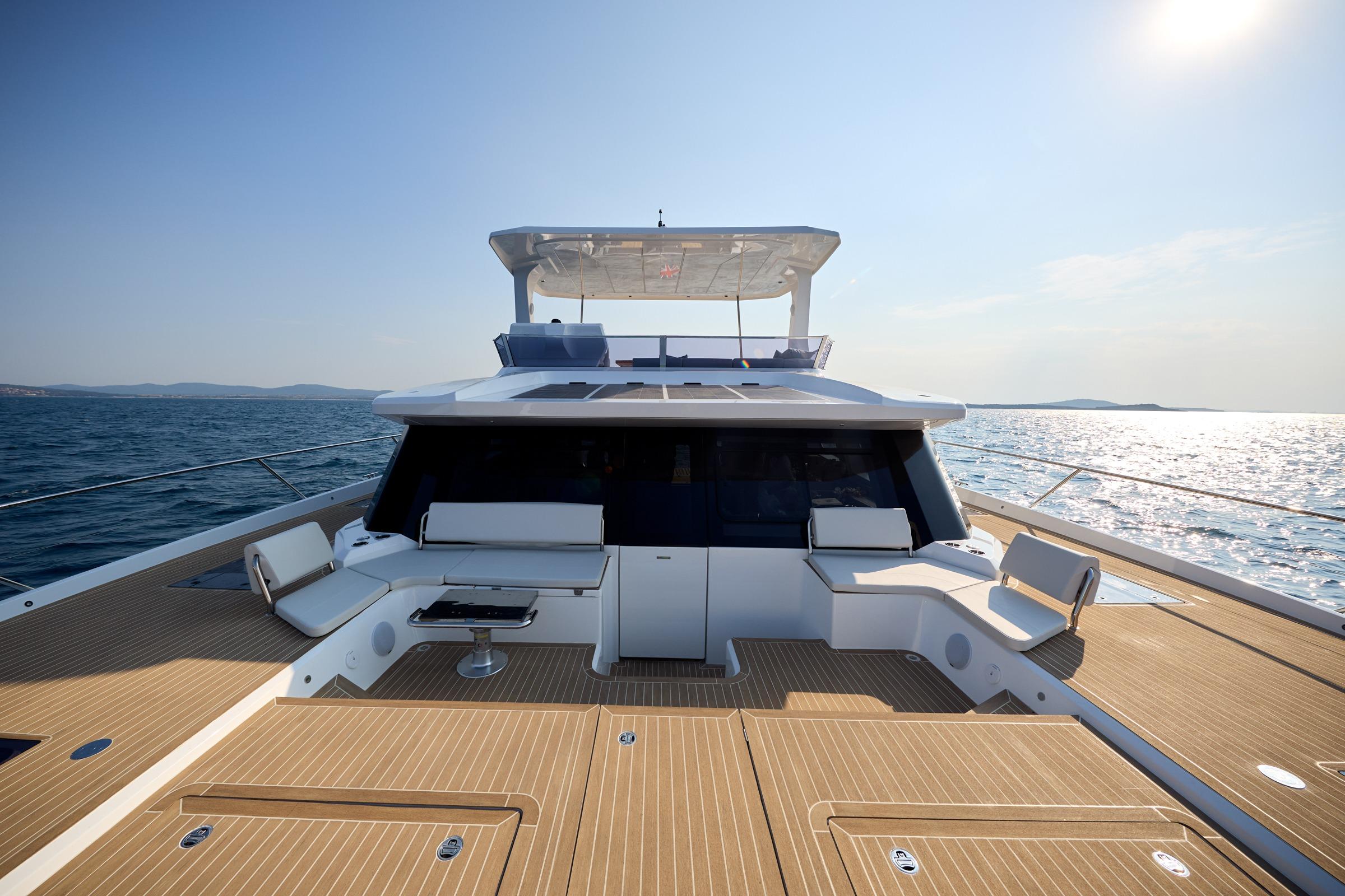 2025 Custom Omaya 50 Power Catamaran on open sea, featuring spacious deck and seating area.