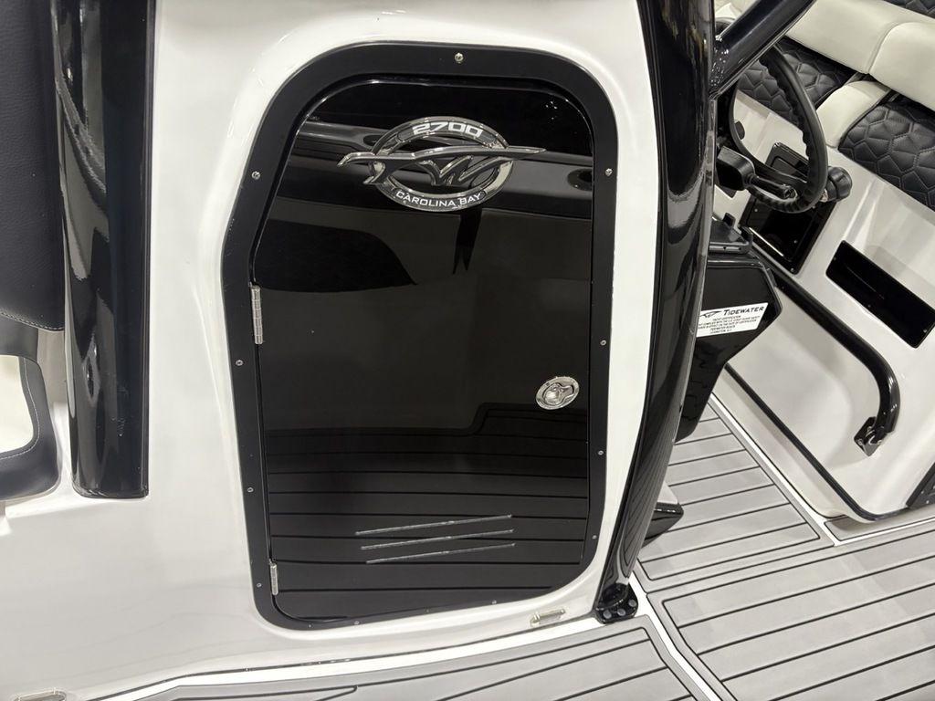 2026 Tidewater 2700 CB boat interior with sleek black door and modern steering wheel.