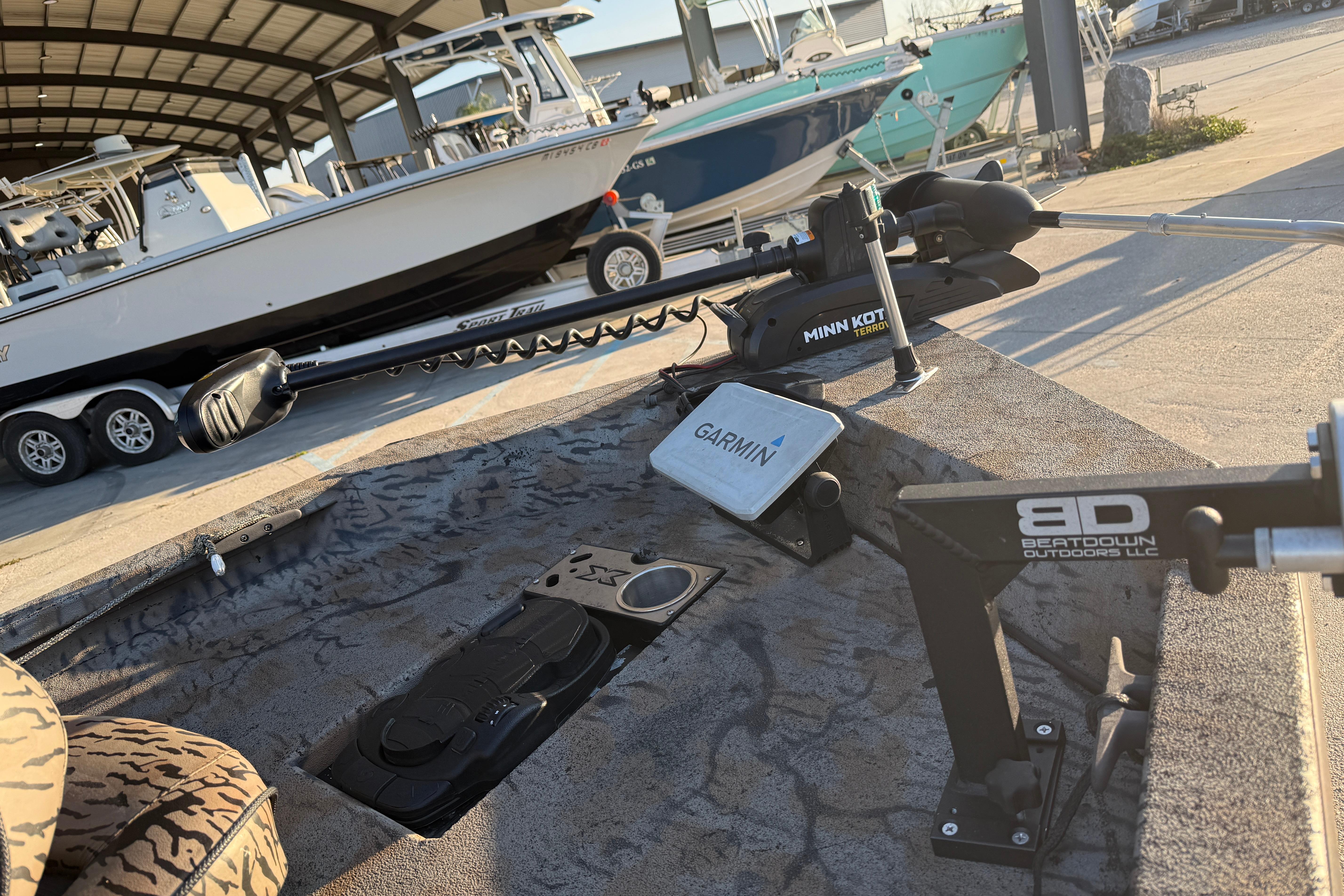 2019 Xpress XP7 boat with Garmin and Minn Kota equipment in a marina setting.