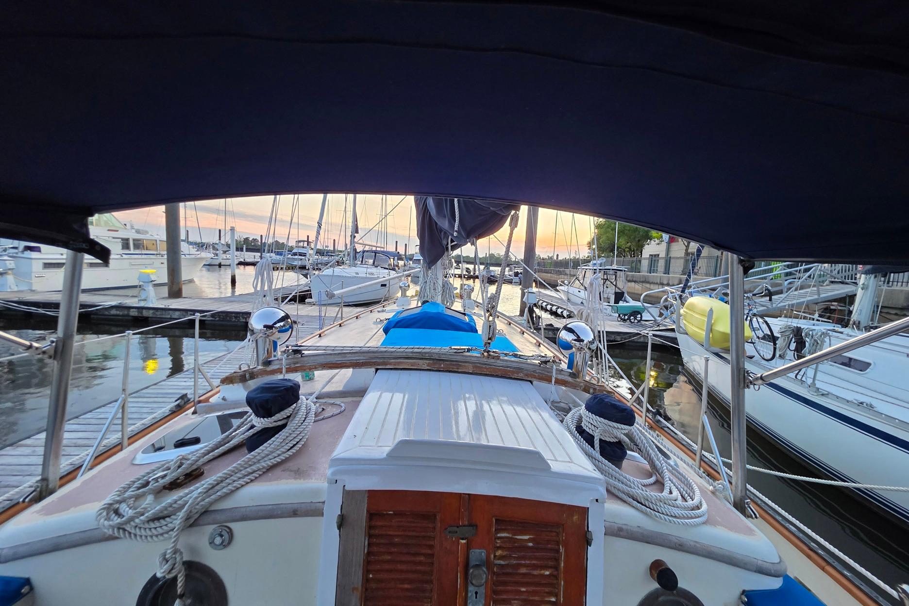1982 Tayana 37 sailboat docked at marina during sunset, showcasing deck and rigging.