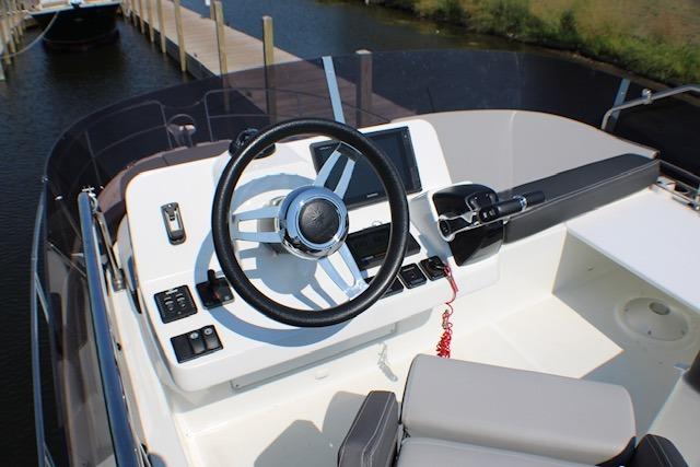 2020 Jeanneau NC 1095 Flybridge helm with steering wheel and control panel.