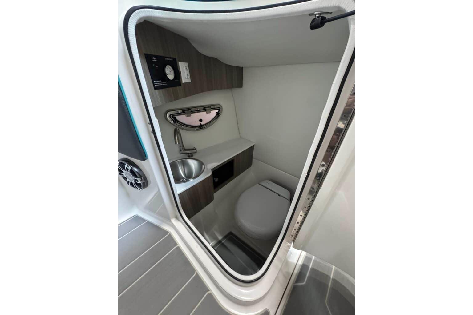 2022 Regal LS6 Surf boat interior bathroom with sink and toilet.
