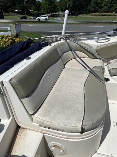 2005 Sea Ray 240 SD boat with cushioned seating in outdoor setting.
