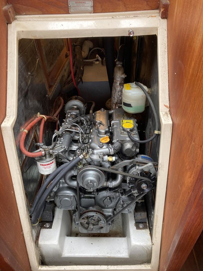 An engine compartment with a Yanmar engine in a Catalina 42 Tricabin boat.