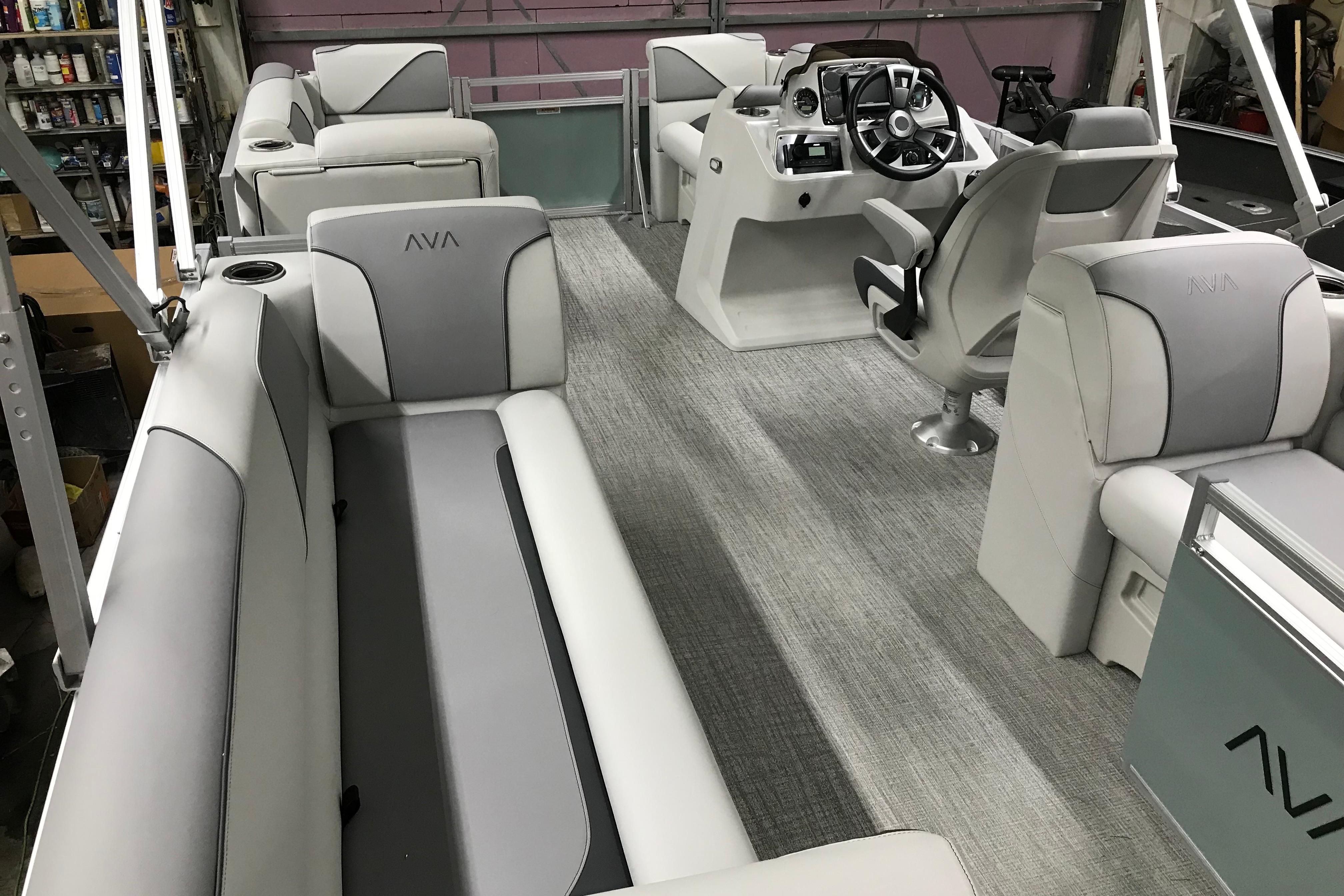 2026 Avalon Venture Quad Lounger 19' interior with modern seating and steering console.