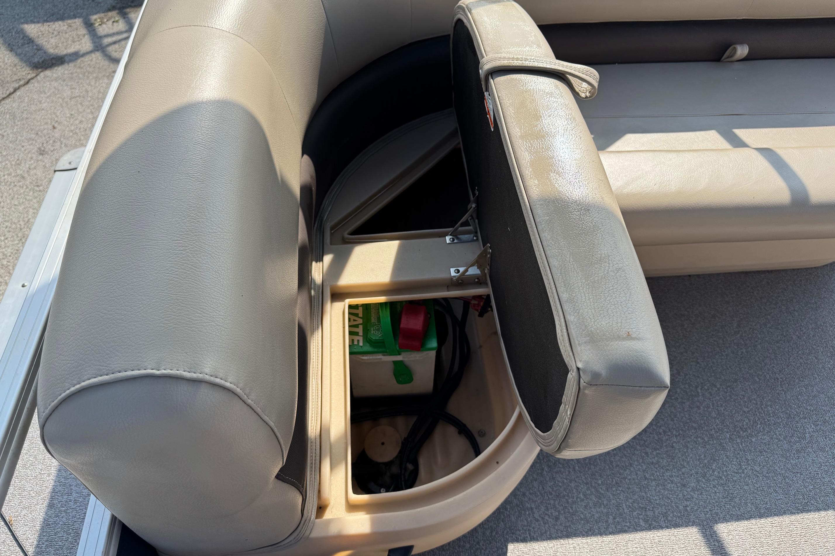 2019 Sun Tracker Party Barge 18 DLX with open storage compartment under seat.