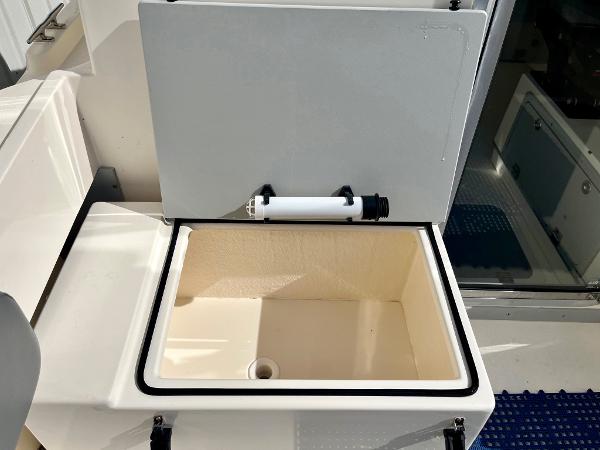Open storage compartment on 2023 Defiance Admiral 220 EX boat.