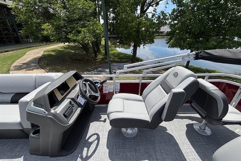 2026 Sun Tracker SportFish 20 DLX pontoon boat interior with steering console and seating.