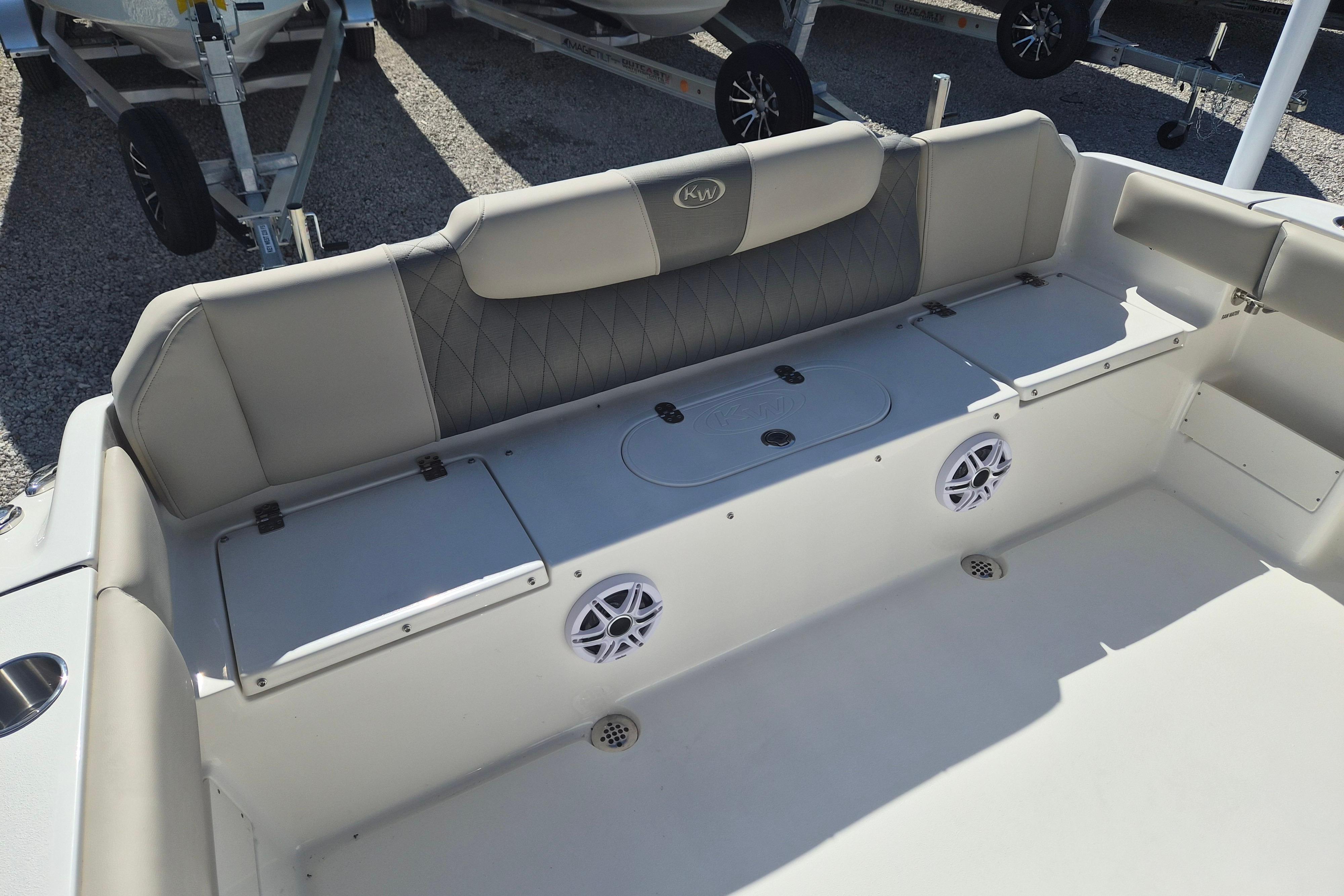 2026 Key West 239 FS boat interior with cushioned seating and storage compartments.