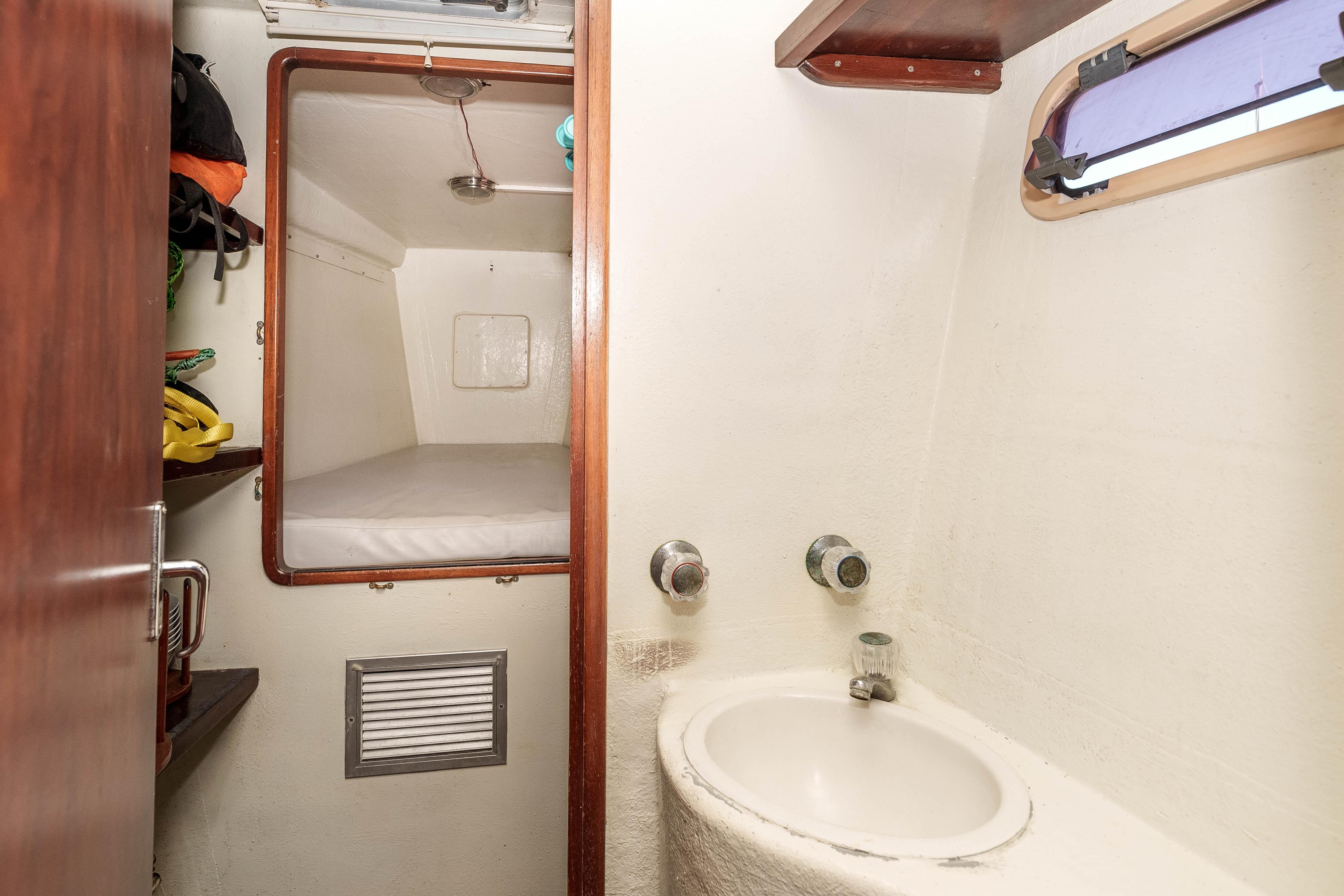 Interior of 2009 Kelsall KSS 58 yacht featuring a compact cabin and sink area.