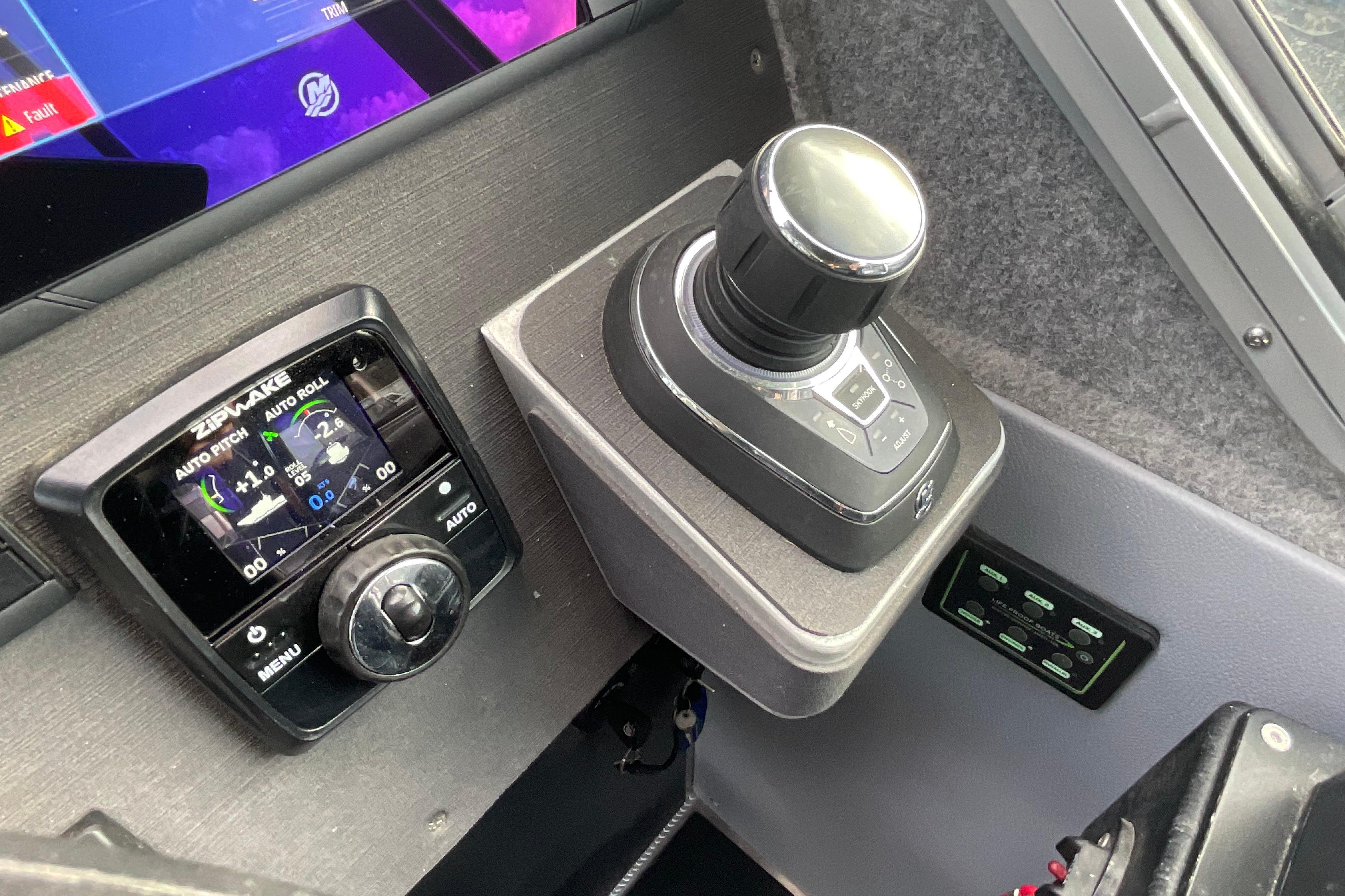 Control panel of 2025 Life Proof 31 GT Coupe with joystick and Zipwake display.