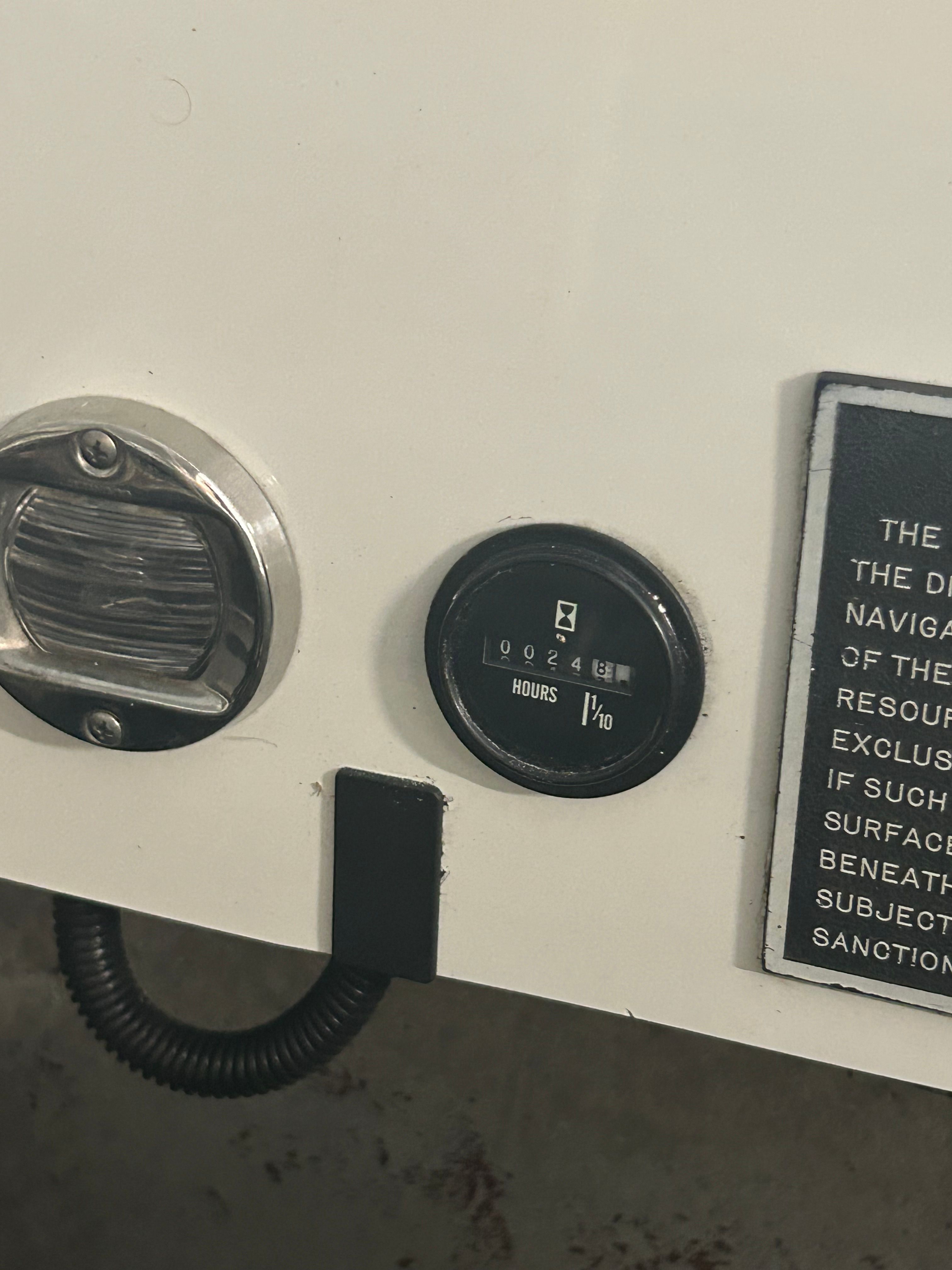 Close-up of a boat instrument panel with an hour meter.