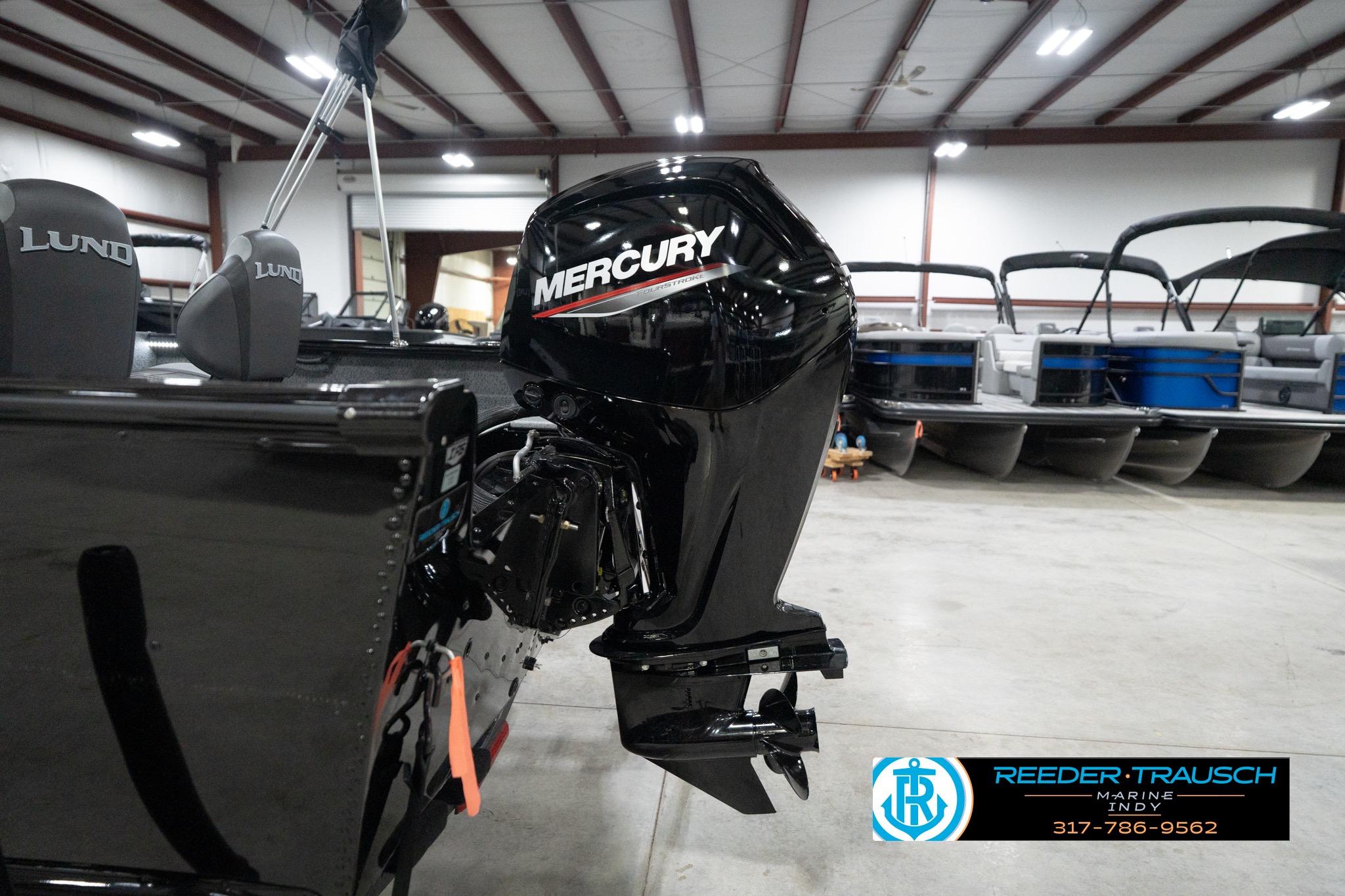 2026 Lund 1800 Explorer Sport with Mercury outboard motor in showroom.