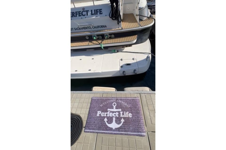 2006 Regal Commodore 4460 yacht named "Perfect Life" docked with welcome mat.
