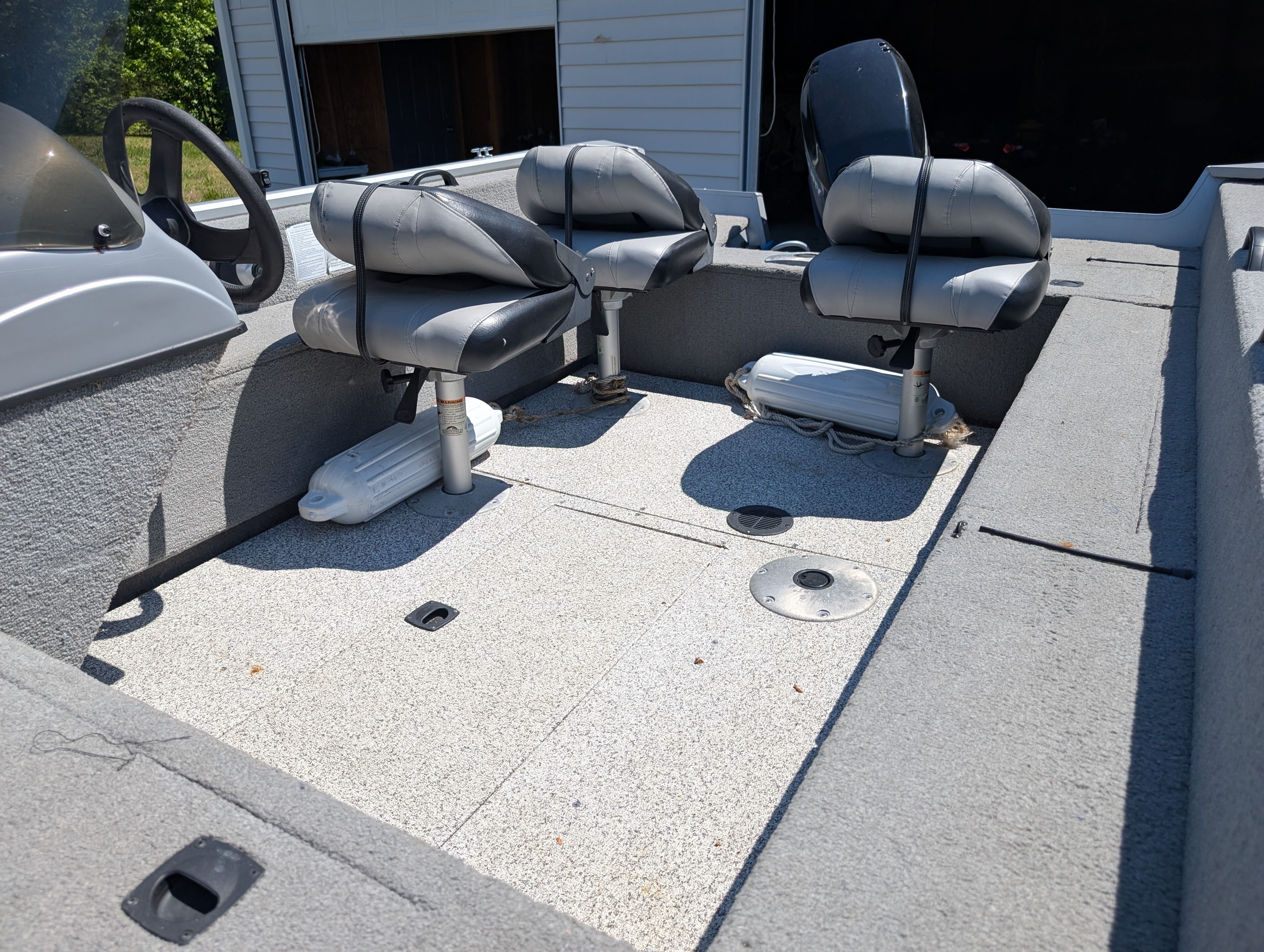 Interior of a 2009 Tracker Pro Guide V16 SE boat with gray seats.