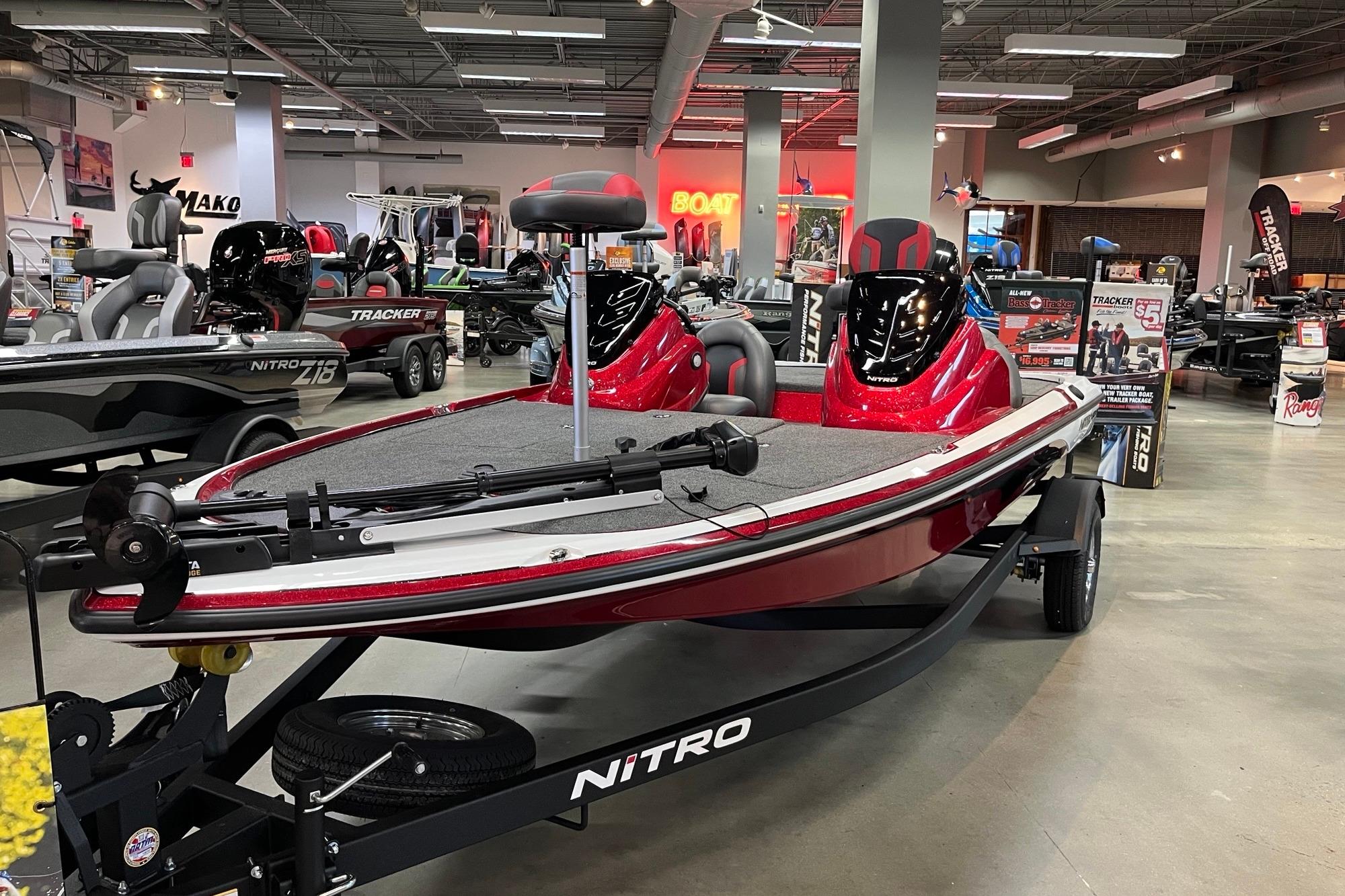 2026 Nitro Z17 boat displayed in showroom, featuring sleek red design and modern seating.