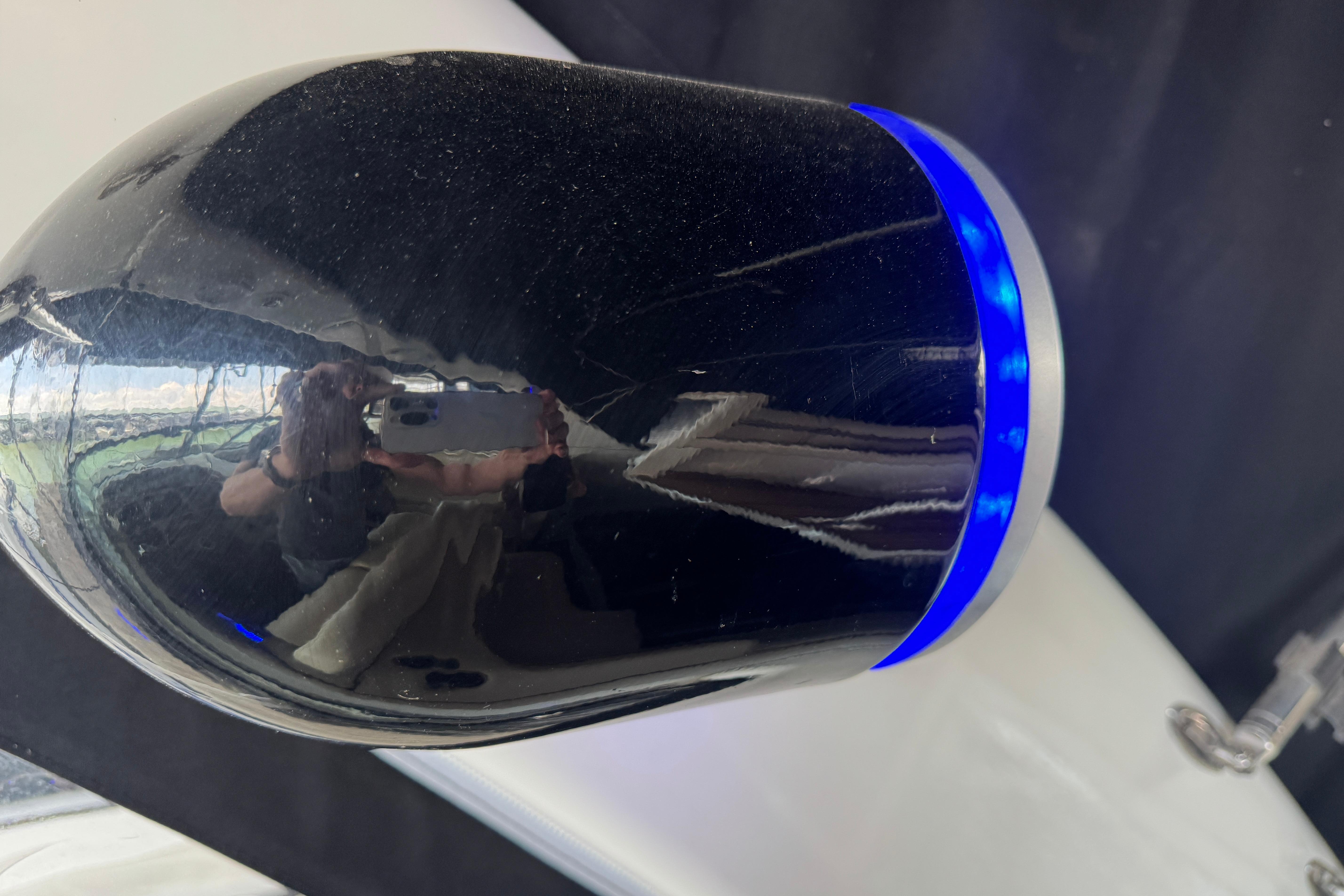 Close-up of a 2006 Chaparral 330 Signature boat's reflective surface with blue LED lighting.