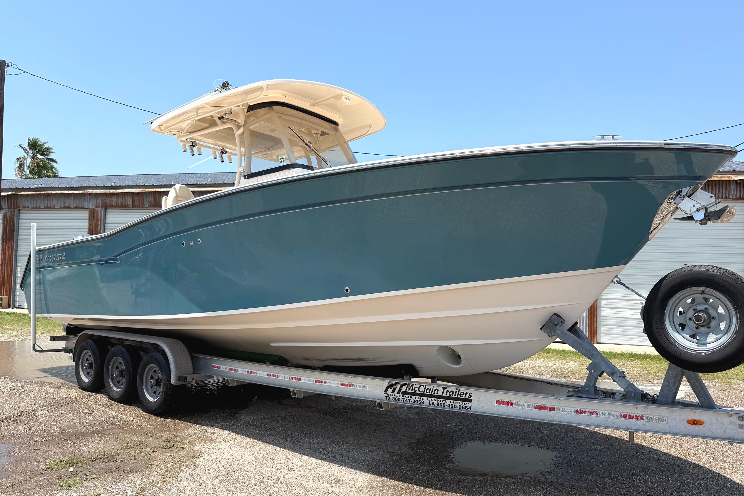 2018 Grady-White Canyon 306 boat on trailer, parked outdoors under clear sky.