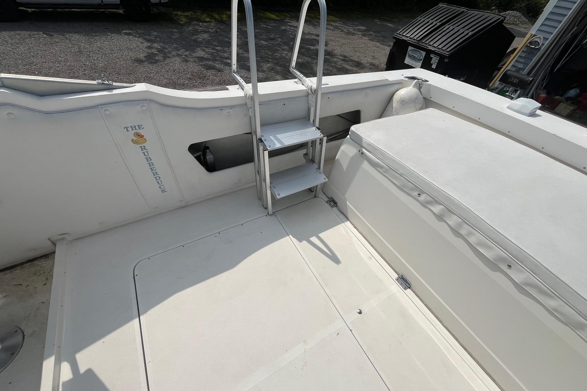 1975 Bertram 26 Moppie boat interior with ladder and seating area.