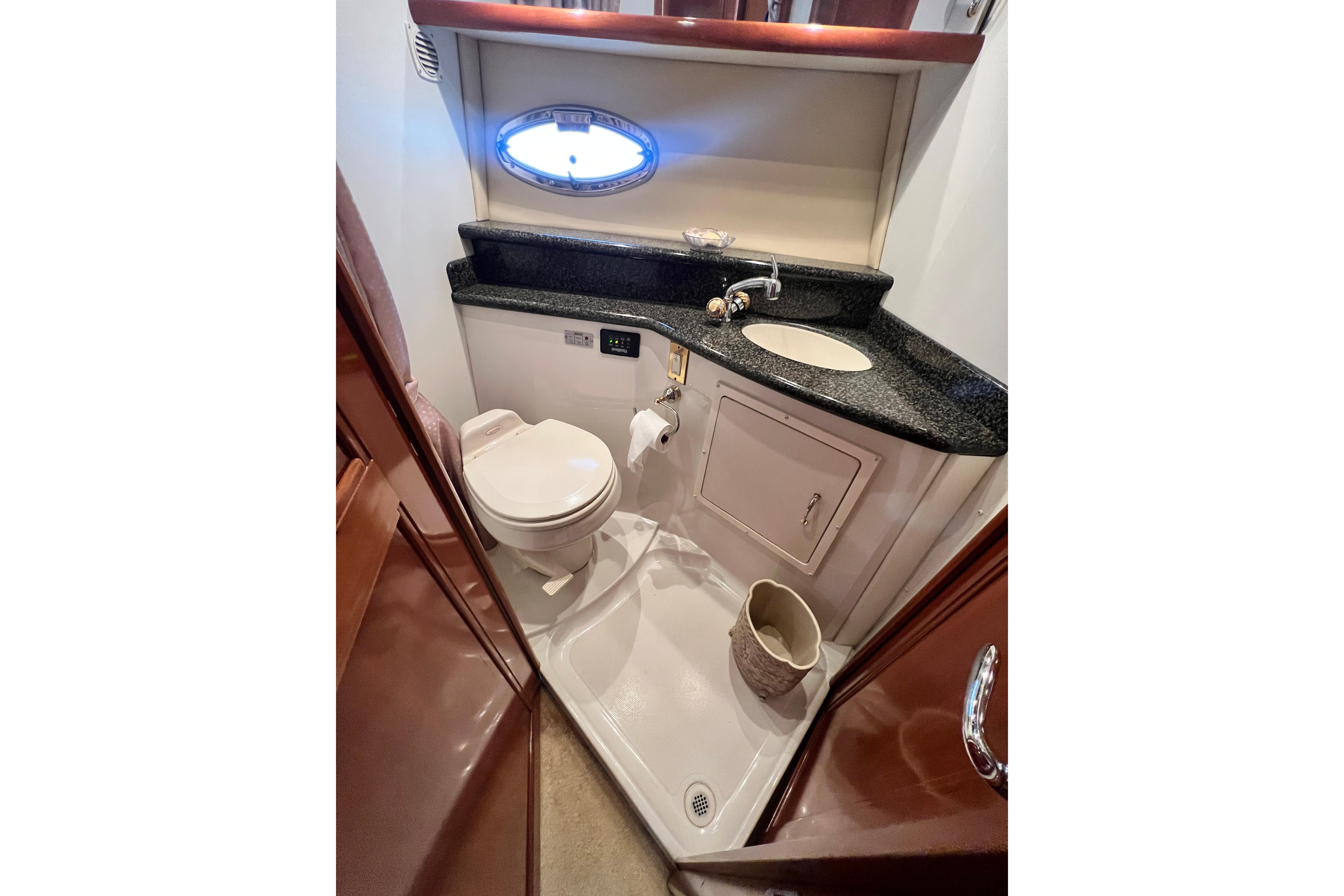 Bathroom interior of 2003 Carver 450 Voyager Pilothouse with sink and toilet.