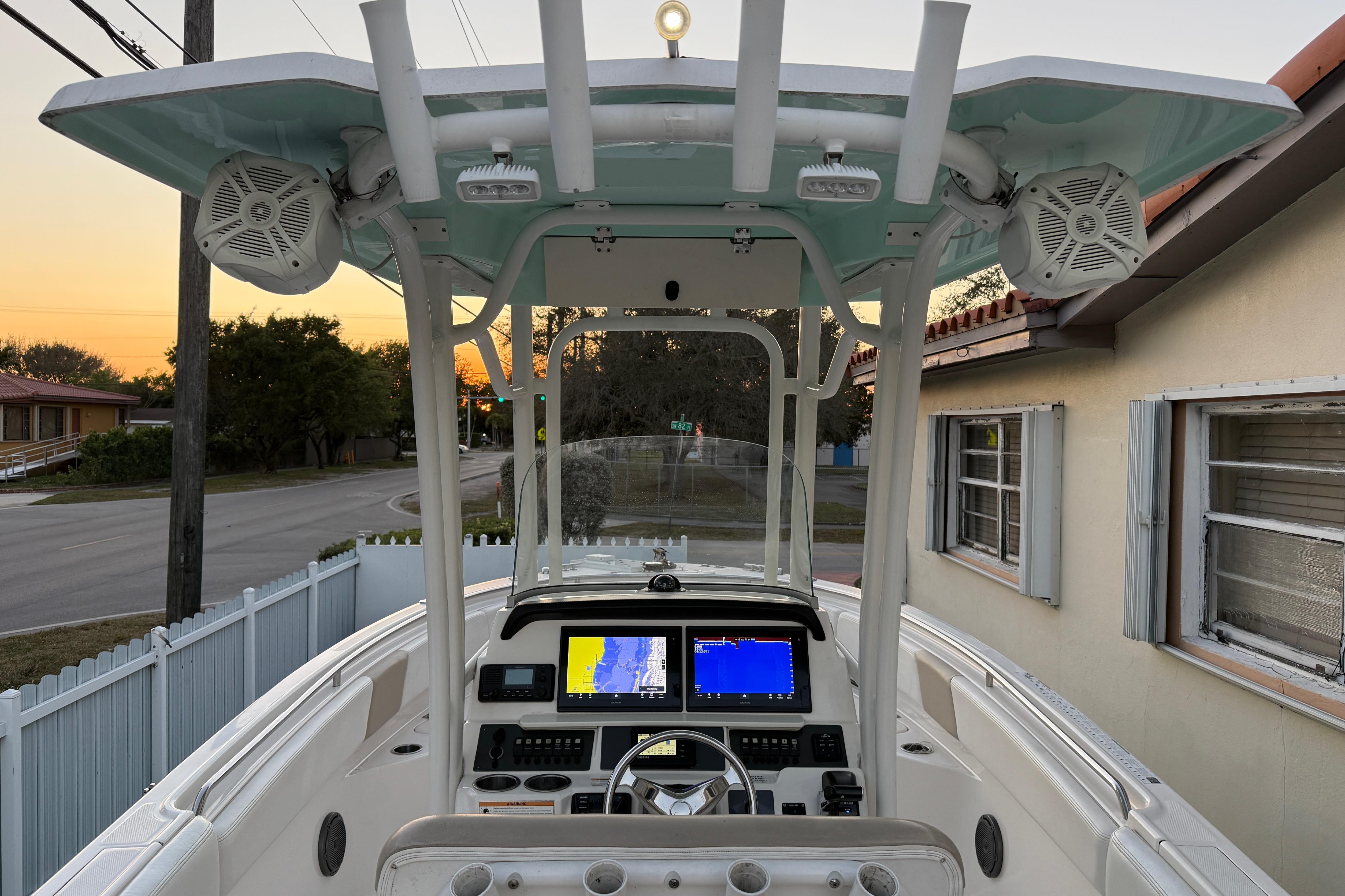 2018 Robalo R242 Center Console boat with advanced navigation system at sunset.