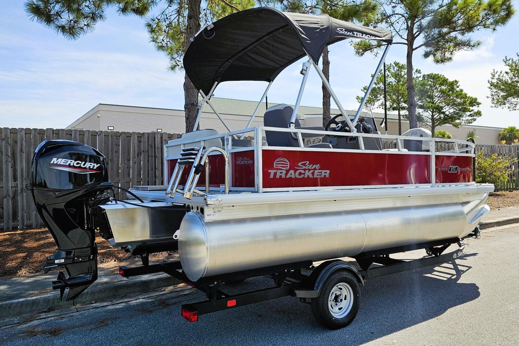 2026 Sun Tracker Bass Buggy 16 XL Select pontoon boat with Mercury outboard motor.