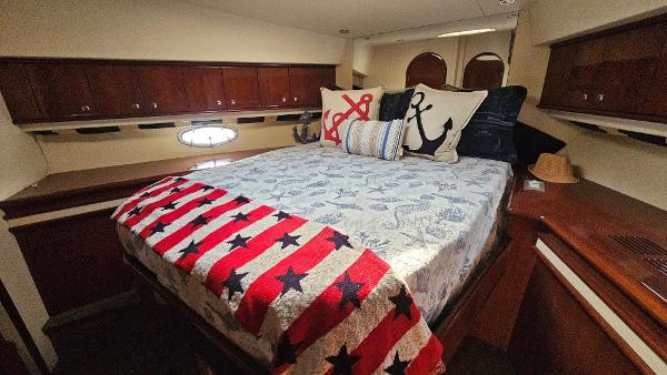 Luxurious bedroom in 2005 Neptunus 56 Flybridge yacht with nautical decor.