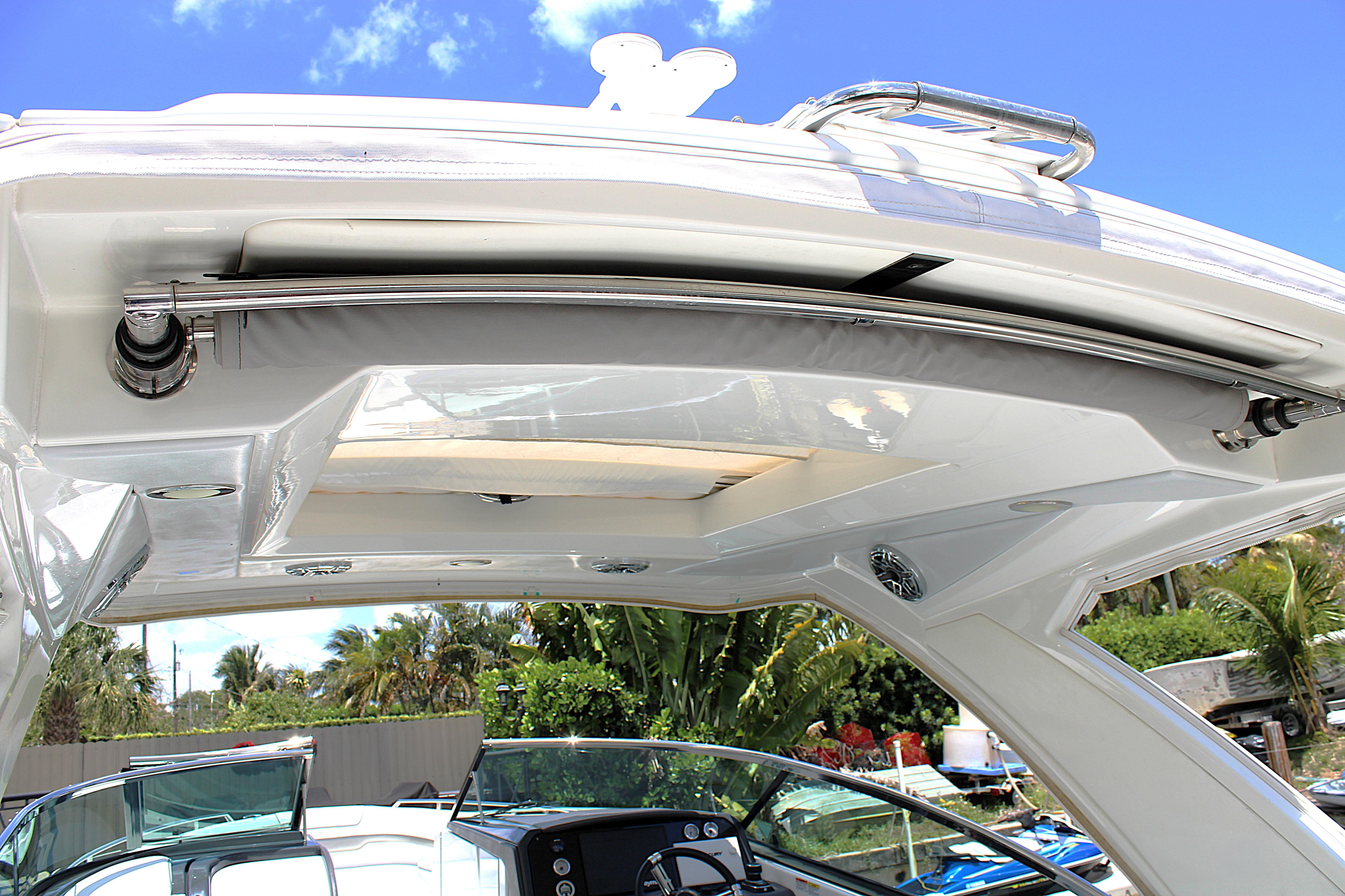2022 Formula 310 Bowrider OB boat canopy and interior view under clear blue sky.