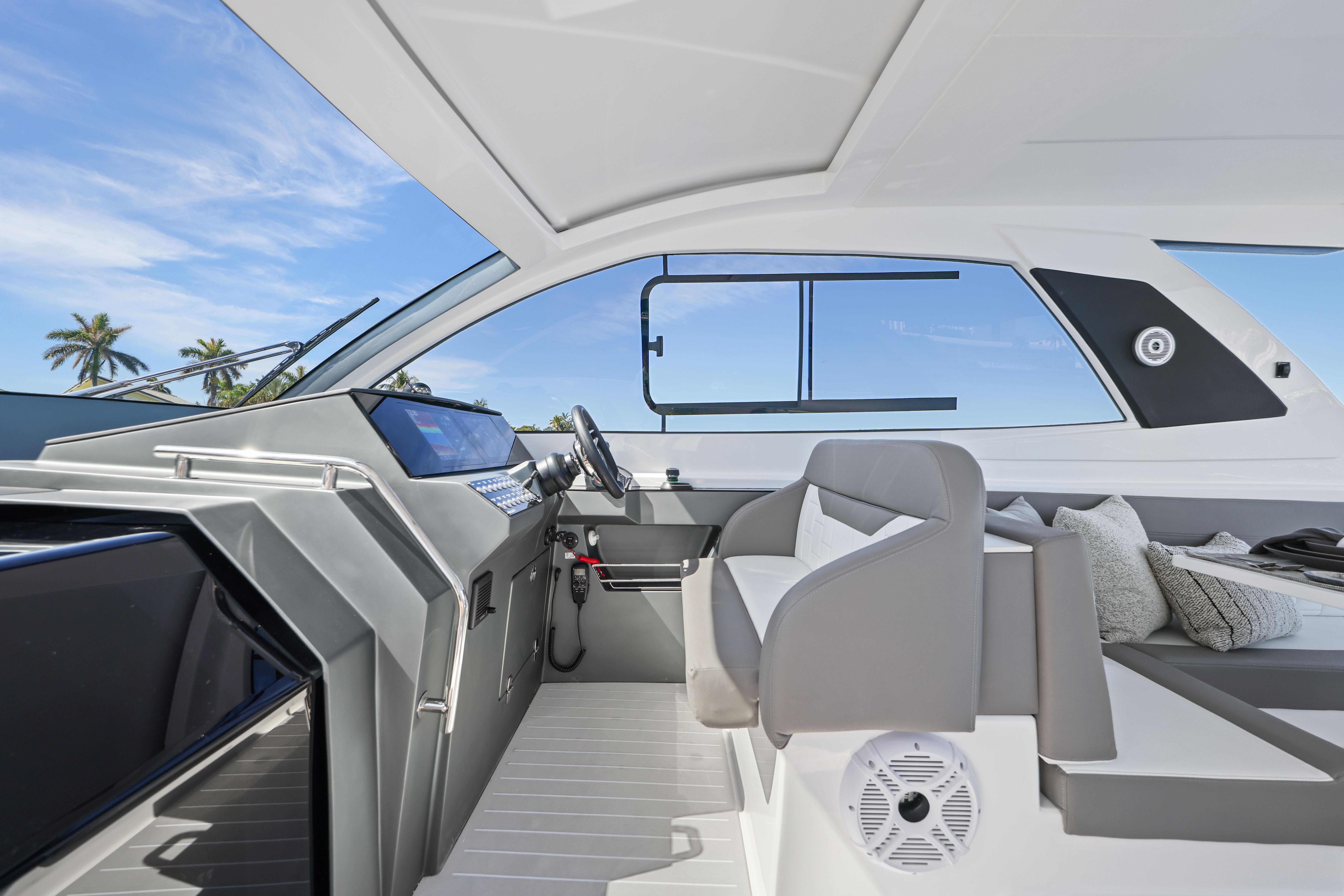 2025 Valiatt 380 Bowrider interior with modern helm, seating, and tropical backdrop.