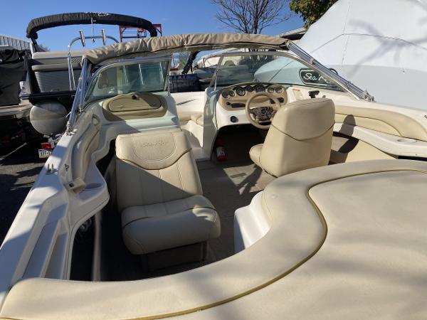 2001 Sea Ray 180 Bow Rider interior with beige seating and dashboard.