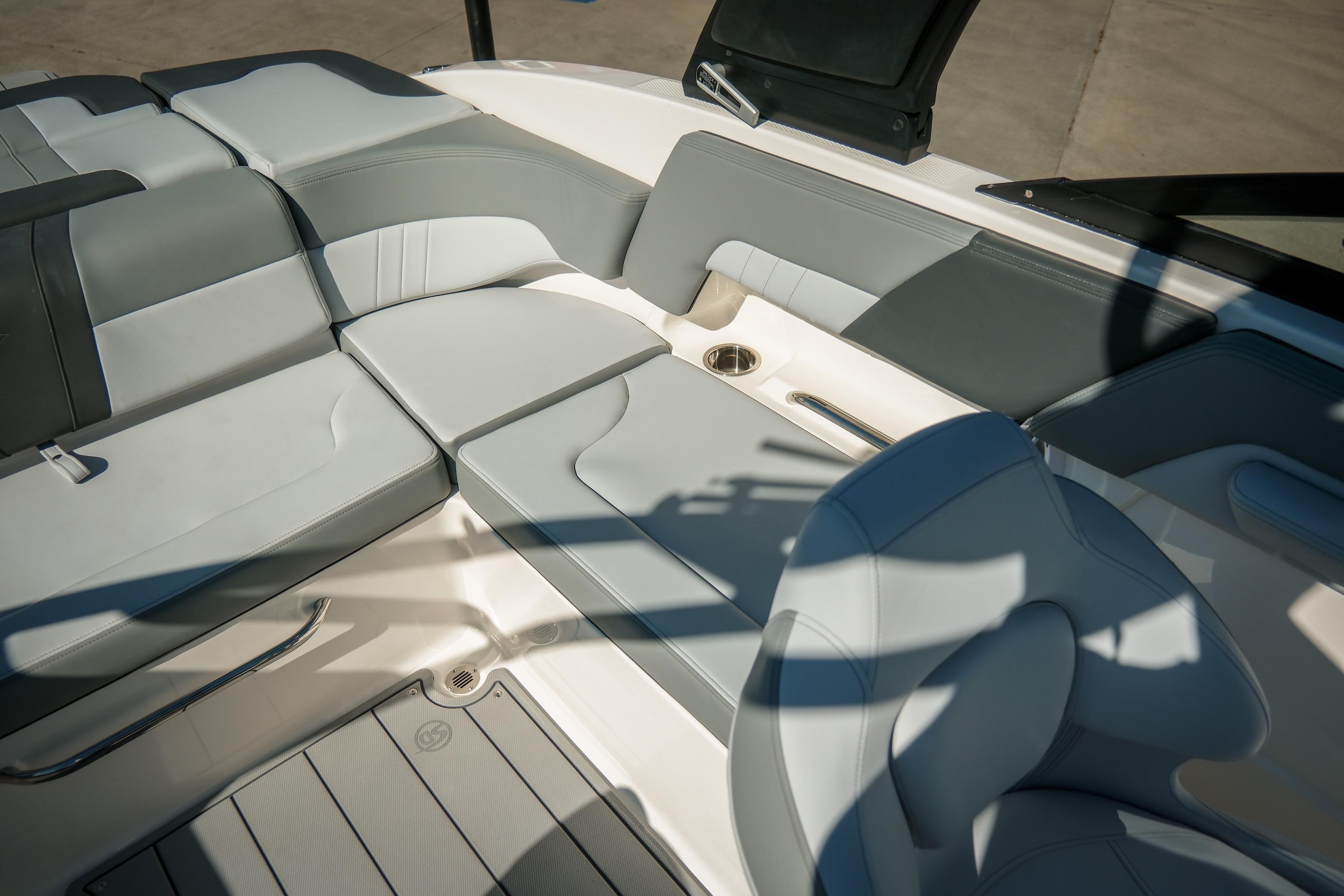2026 Chaparral 23 SSi boat interior with gray and white seating, cup holder, and sleek design.