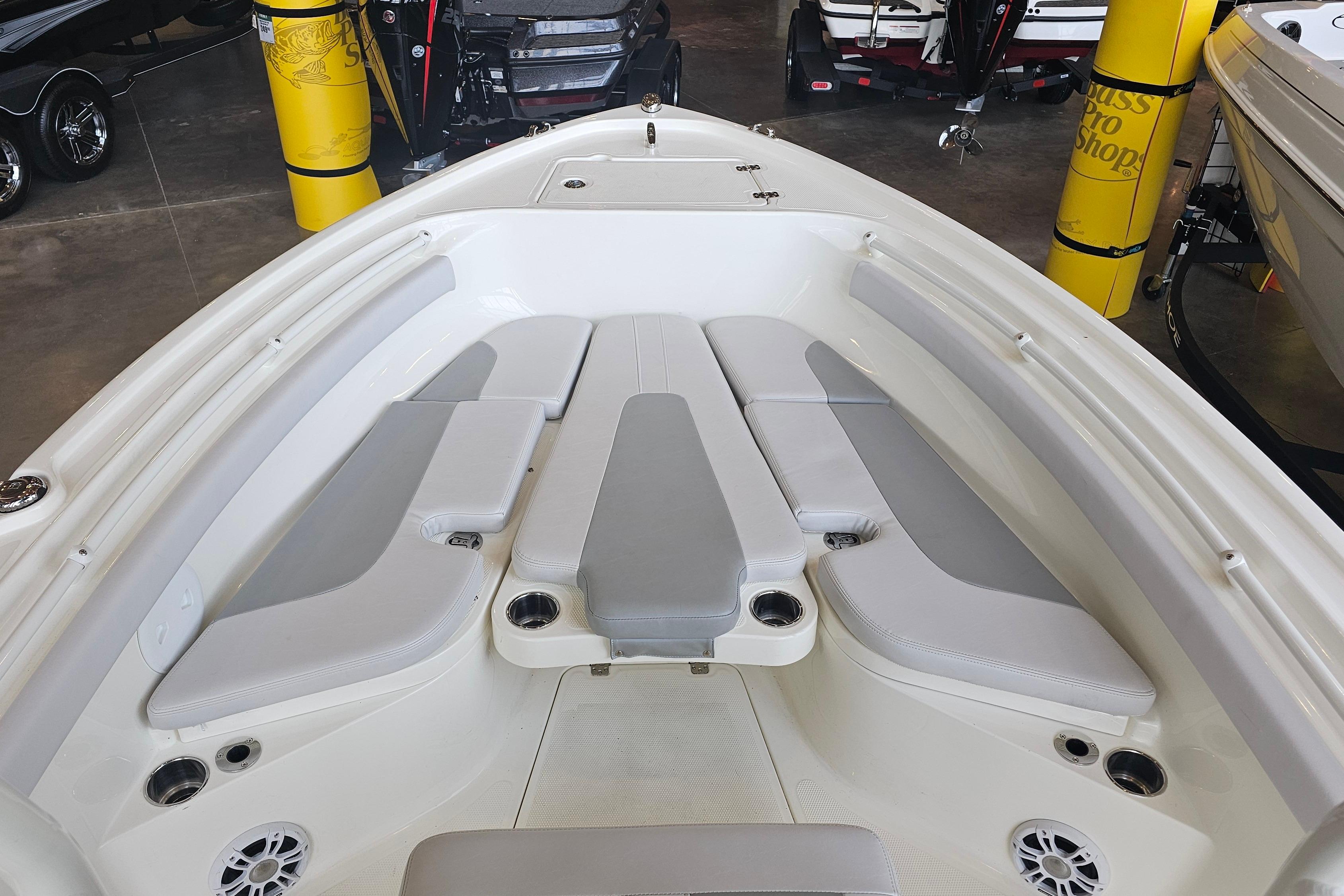 2025 Mako 214 Center Console boat interior with cushioned seating and cup holders.