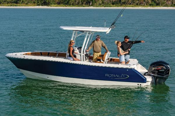 Manufacturer Provided Image: 2025 Robalo R230 Center Console boat with people fishing on calm water.