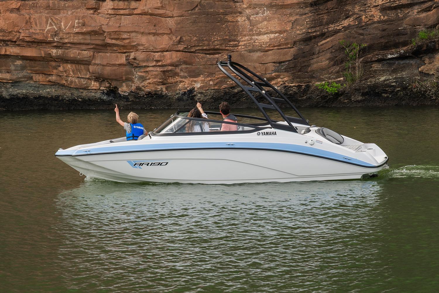 Manufacturer Provided Image: 2026 Yamaha Boats AR190 cruising on a scenic river near rocky cliffs.