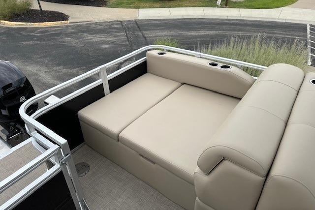 2025 Sun Tracker Sportfish 24 XP3 pontoon boat with beige seating and cup holders.