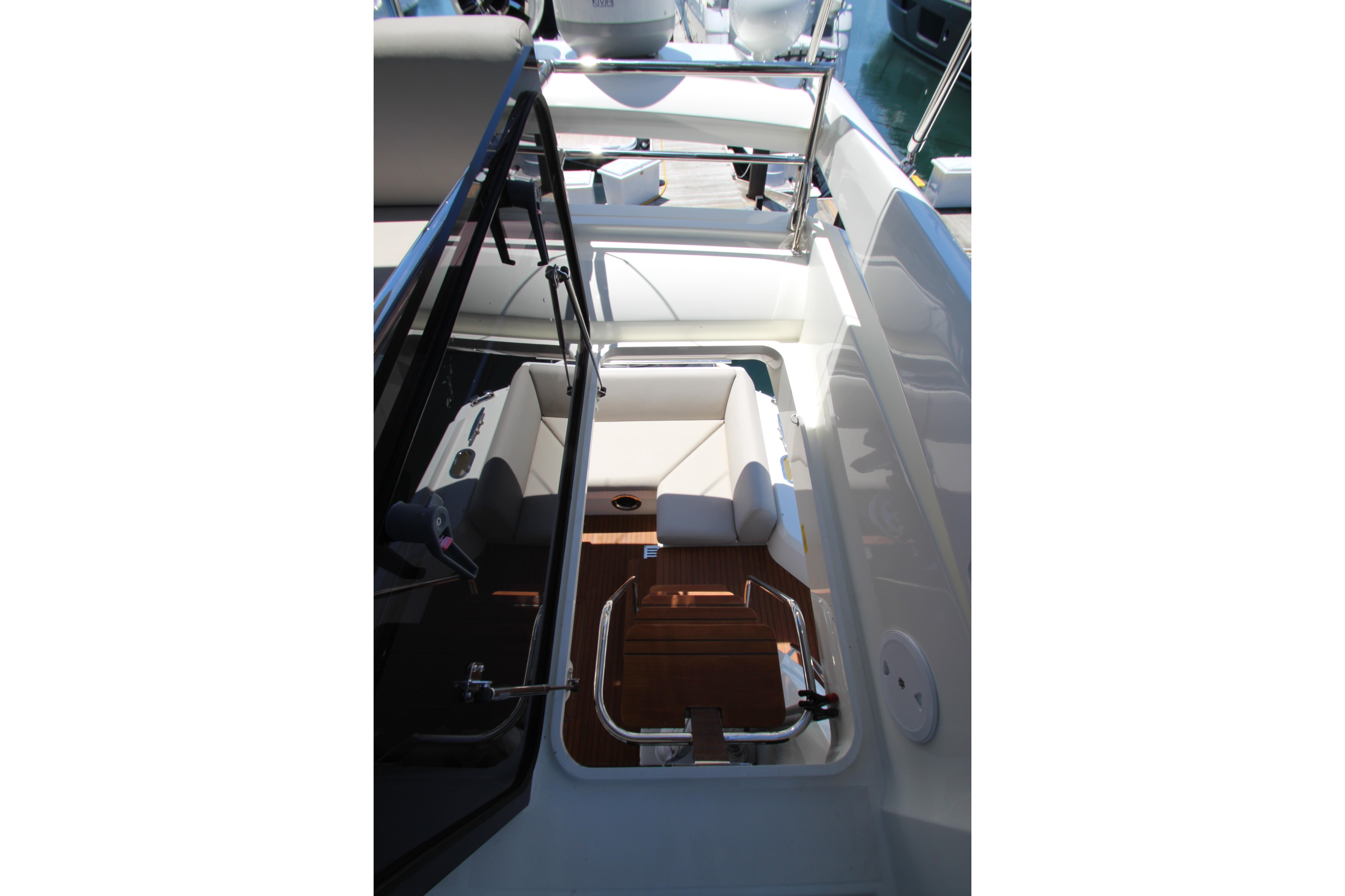2022 Prestige 520 yacht interior with seating and polished wood flooring.