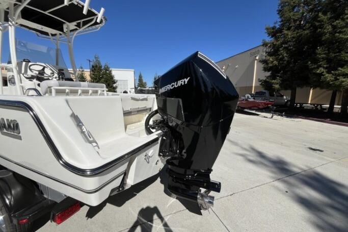 2025 Mako 214 Center Console boat with Mercury outboard motor in a sunny outdoor setting.