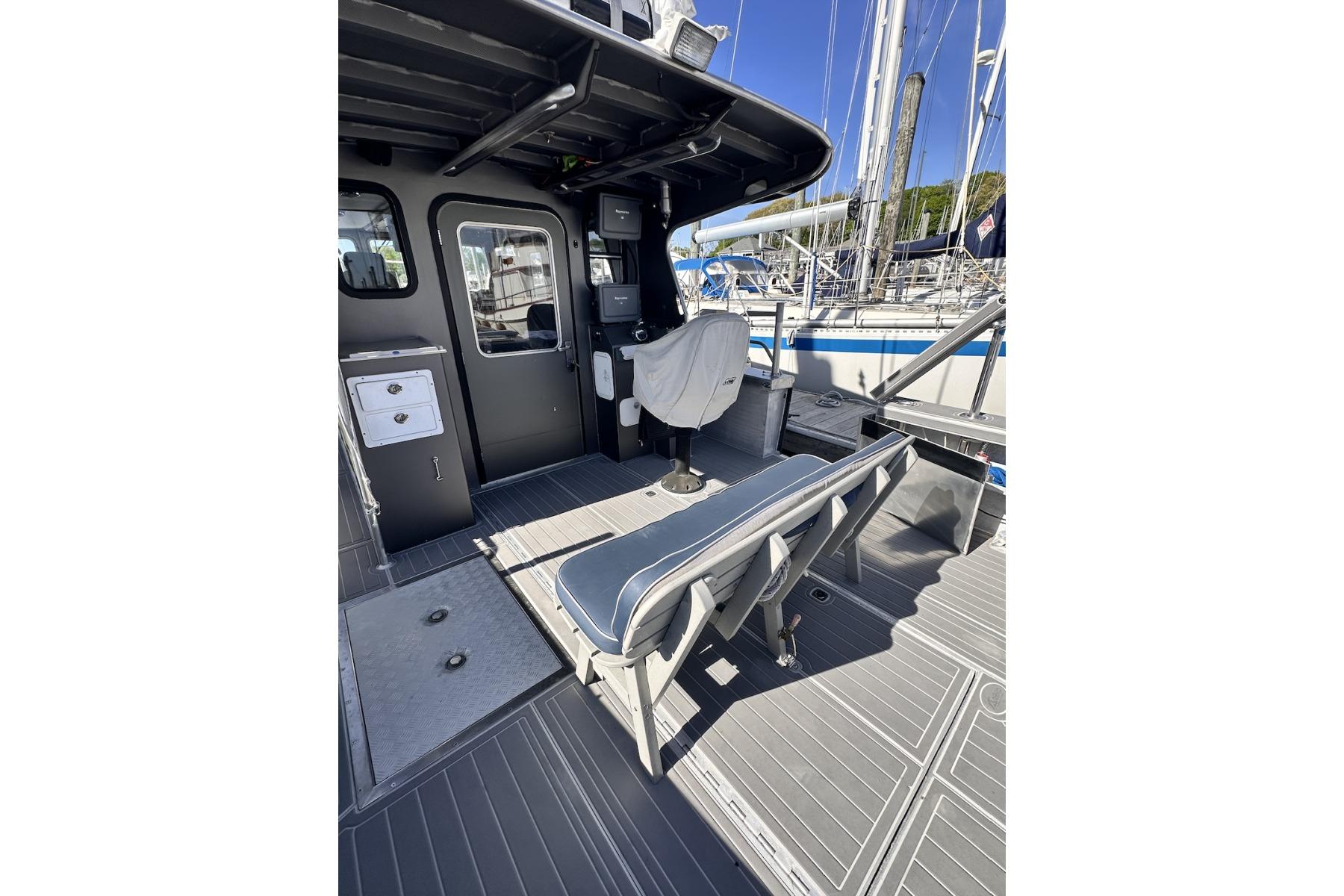 2009 Hunt 35 boat interior with seating and control area, docked at marina.