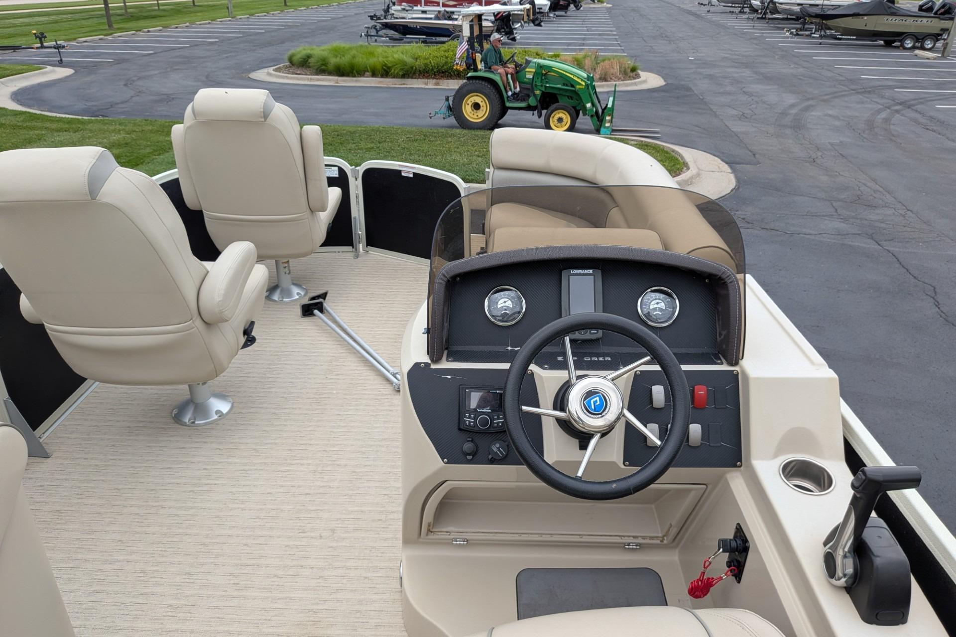 2018 Premier 220 SunSation boat interior with steering wheel and beige seating.