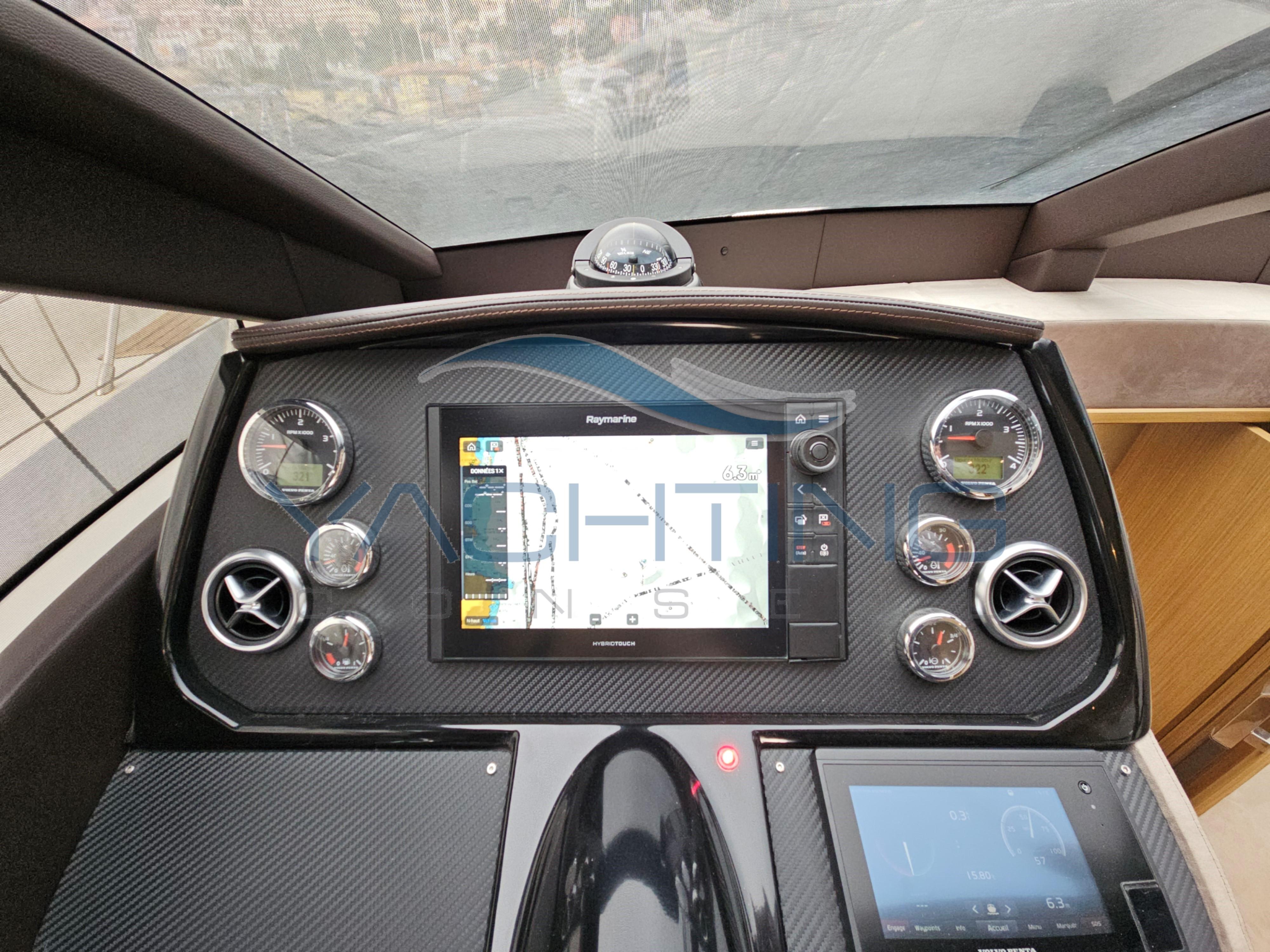 Control panel of a 2018 Absolute 45 FLY yacht with navigation display and gauges.