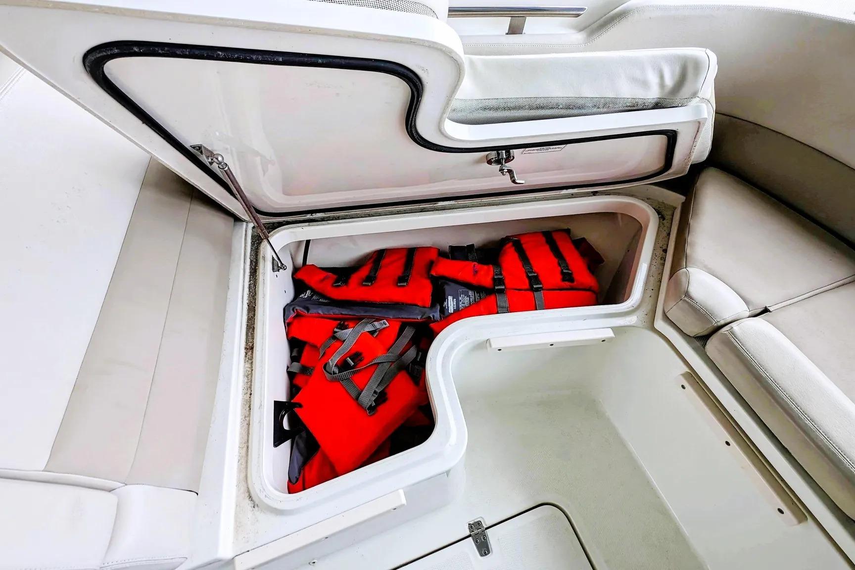 Storage compartment with life jackets on a 2017 Boston Whaler 320 Vantage boat.
