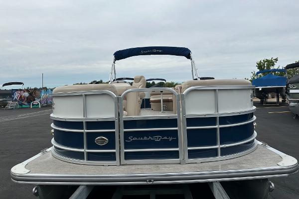 A 2018 South Bay S224CR pontoon boat on a trailer, featuring blue and white details.