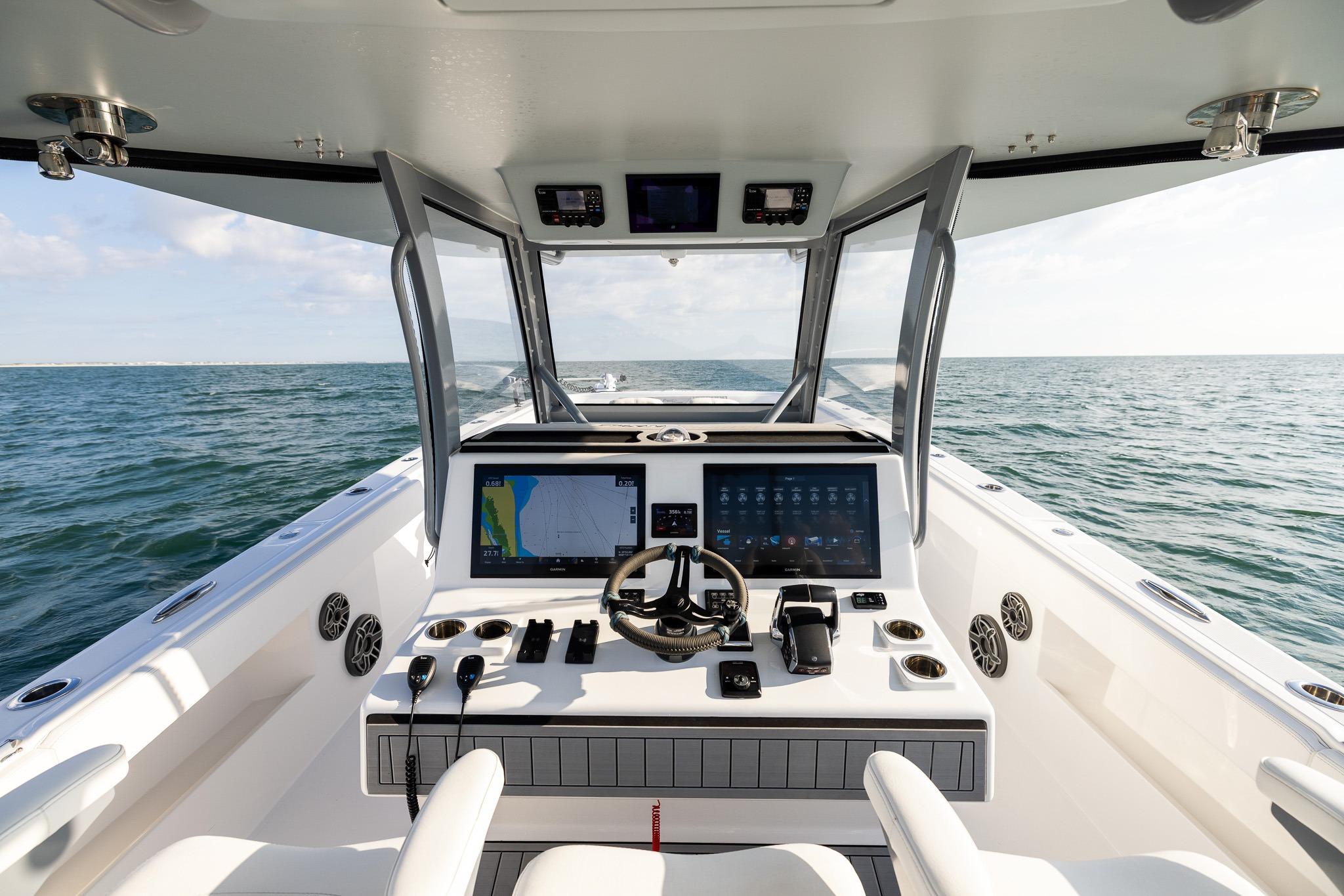 Modern helm of 2026 Front Runner 37 Catamaran with dual screens and ocean view.
