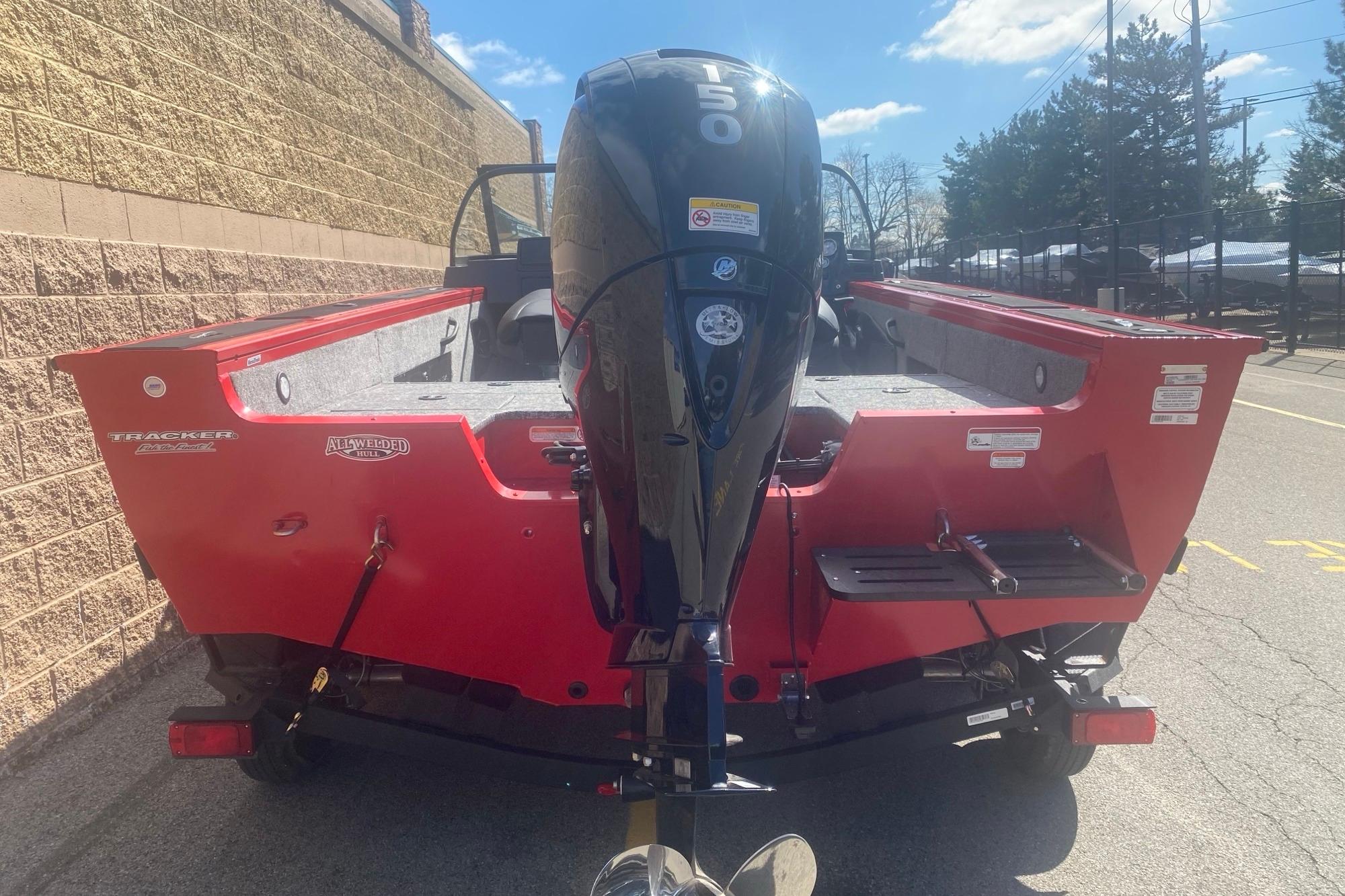 2026 Tracker Targa V-18 WT boat with a powerful 150 HP engine, parked outdoors.