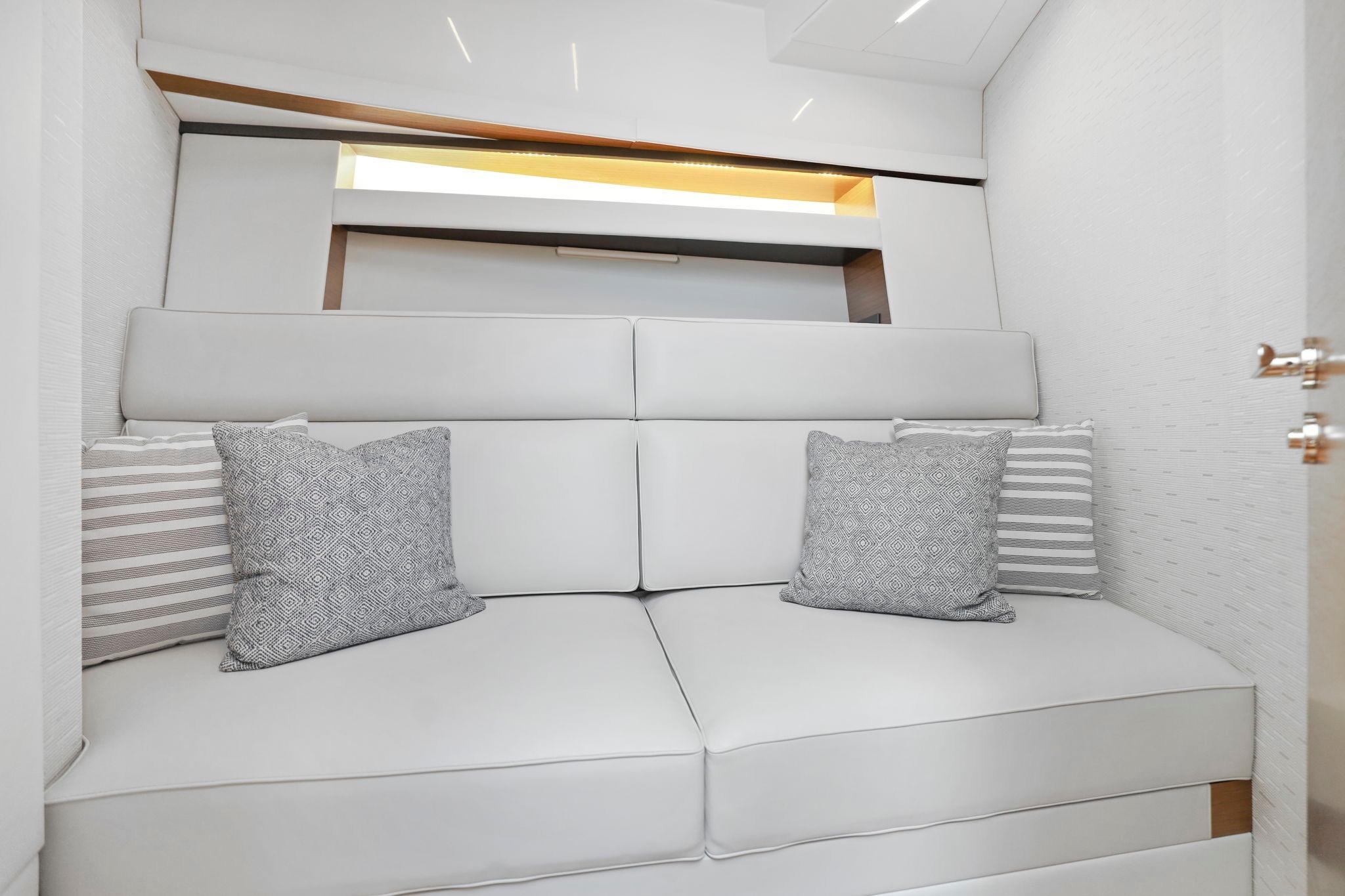 Luxurious interior of 2023 Tiara Yachts C49 Coupe with elegant cushions and modern design.